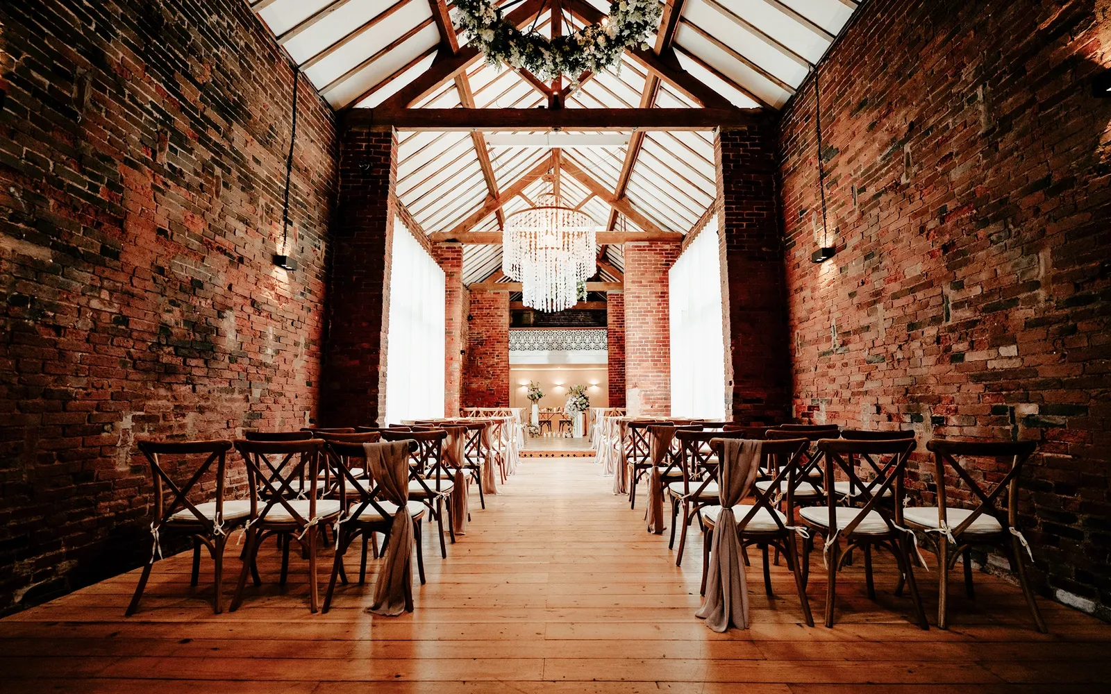 The Long Barn set for a ceremony beneath the vaulted ceiling at Blackbrook Barns, Lichfield, Staffordshire