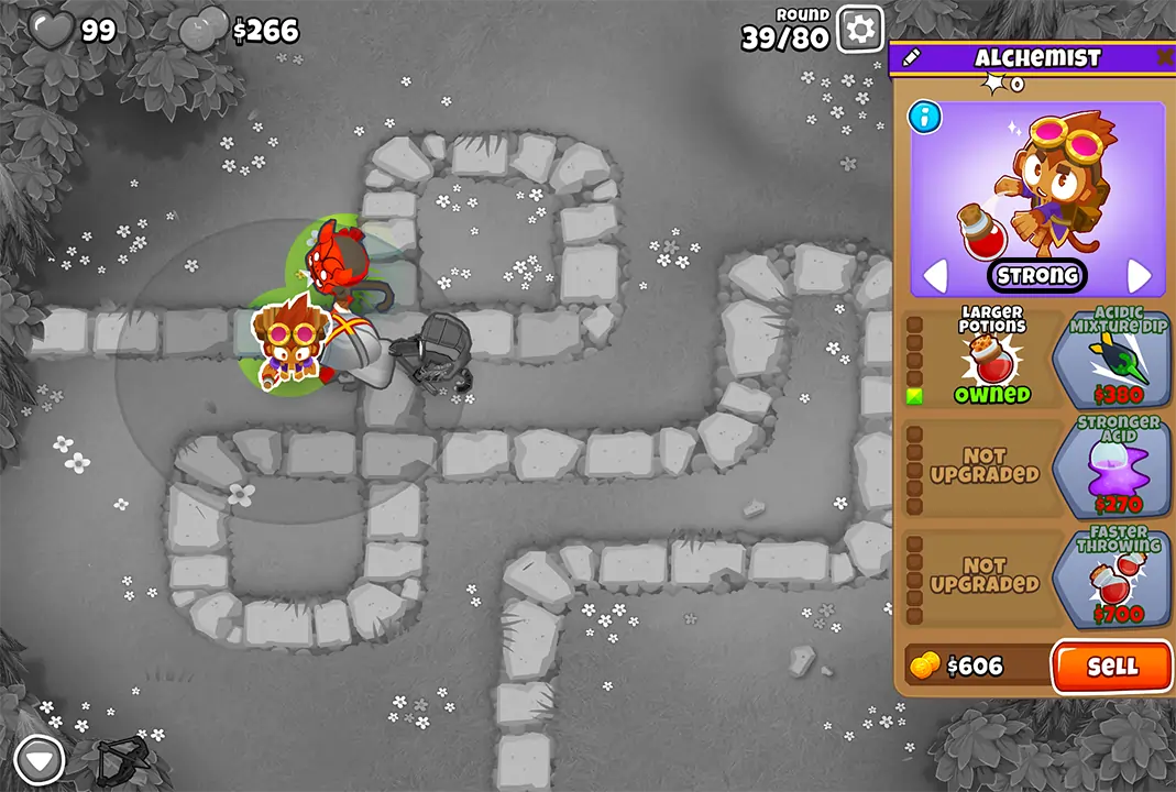 Bloons TD 6 screenshot of Round 39 on Monkey Meadow for Double HP MOABs mode. The Alchemist, selected and upgraded with Larger Potions, is visible. Nearby are a Heli Pilot and Quincy, all working together to stop the bloons.
