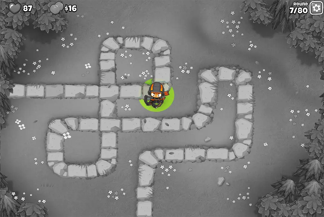 Bloons TD 6 screenshot of Round 7 on Monkey Meadow for Half Cash mode. Quincy is present on the path, continuing the early game defense with the player's life count at 87.