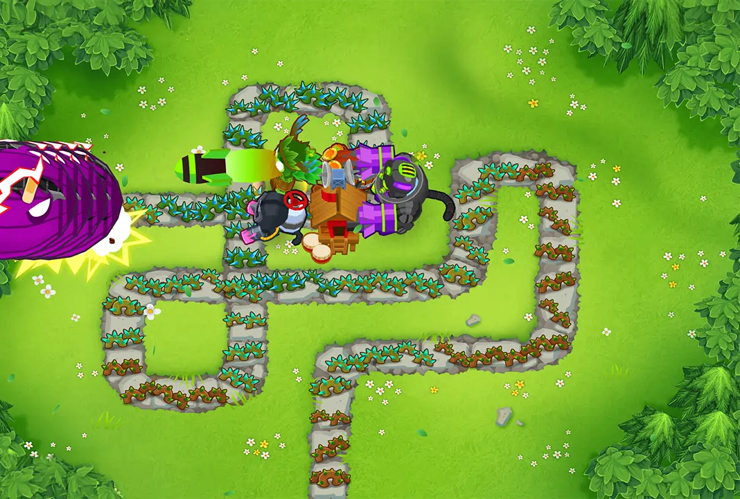 BTD6 game screen showing a full tower setup with a Druid, Alchemist, Glue Gunner, Monkey Village, and Dartling Gunner placed on the map. The towers are actively engaging a large purple MOAB-class bloon approaching from the left side of the screen.