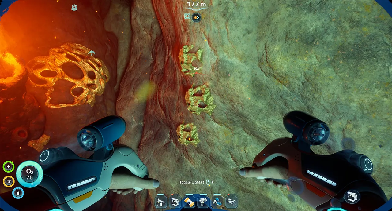 Gold nodes embedded in rock beside glowing lava in the hot biome of Subnautica 2, viewed from the Tadpole at 177 meters