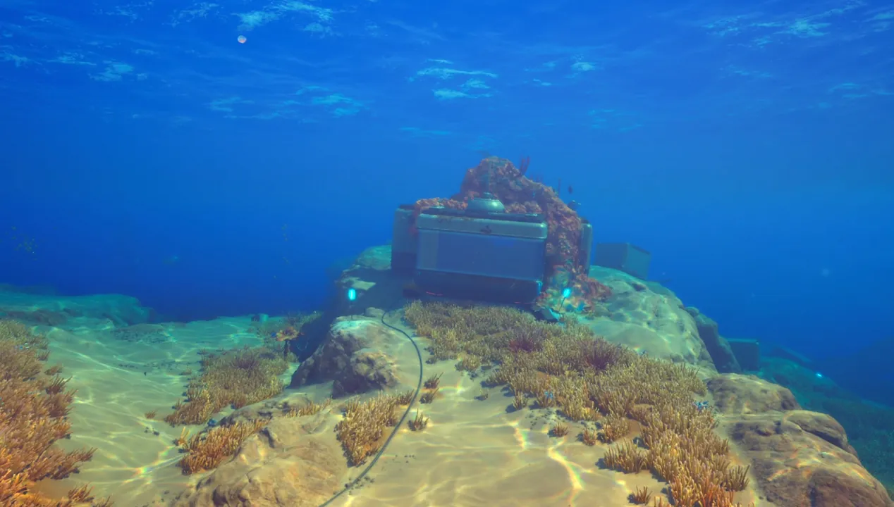 The first black box wreck resting on a sandy ridge in the shallows of Subnautica 2 with glowing markers nearby