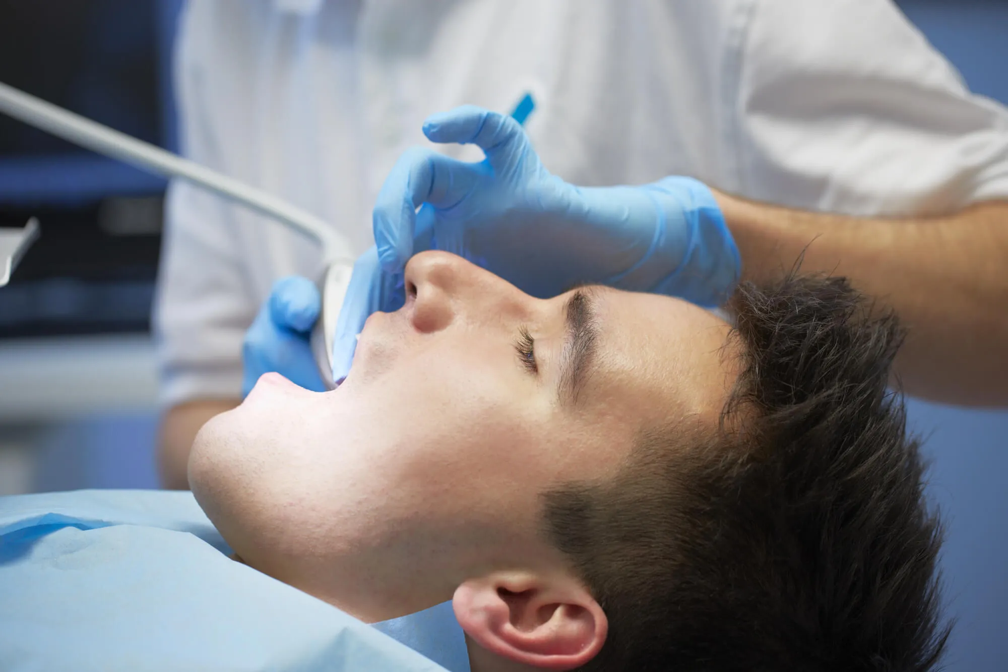 dentist boynton beach fl checks patient's teeth