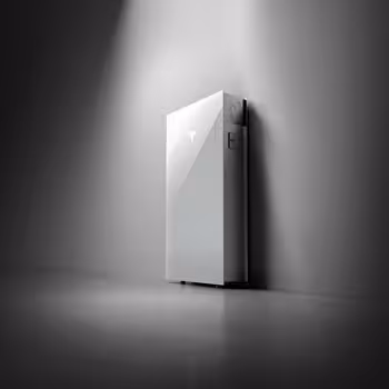 Tesla Powerwall 3 up against the wall with a light shining on it.
