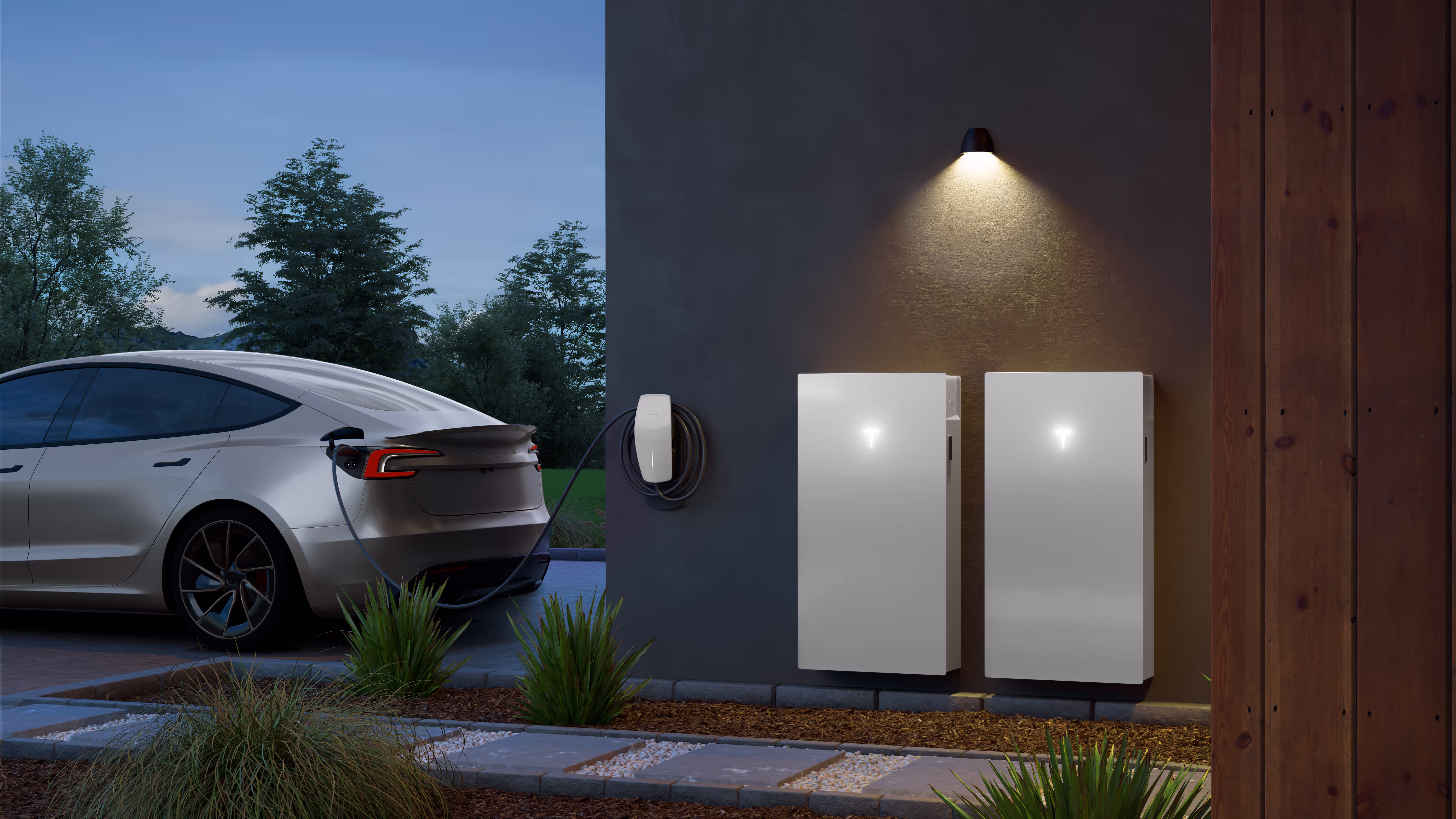 2 Tesla Powerwall 3 batteries on a residential home near a Tesla vehicle.
