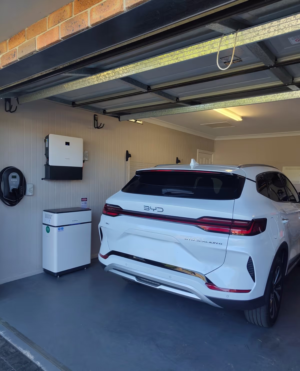 Sungrow SBH and inverter in a residential garage next to a BYD