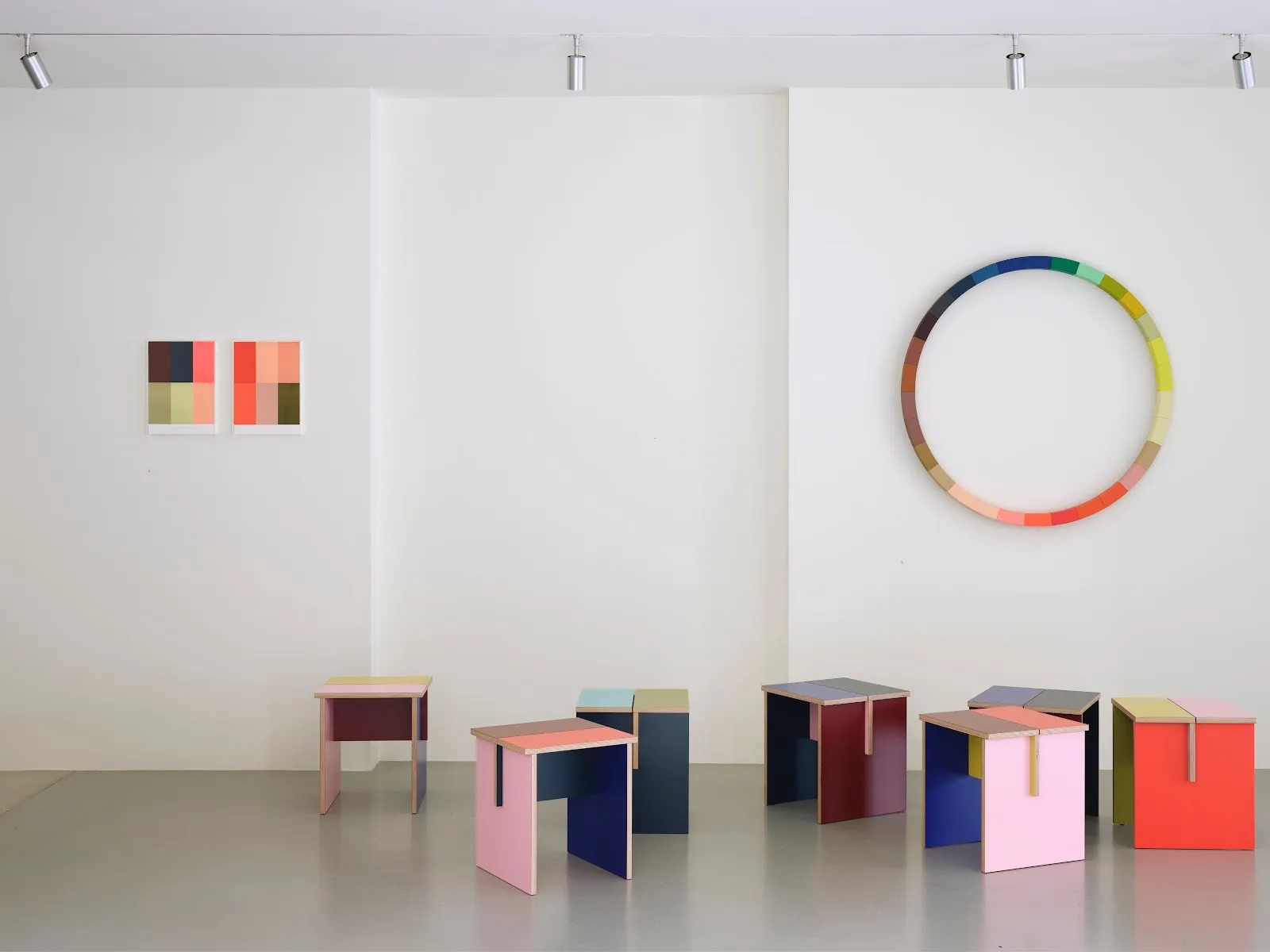 Combination Table by Sophie Smallhorn for Uncommon Projects, shown in a gallery setting beneath one of Smallhorn’s wall sculptures. The image highlights the relationship between colour, form and structure in both works.
