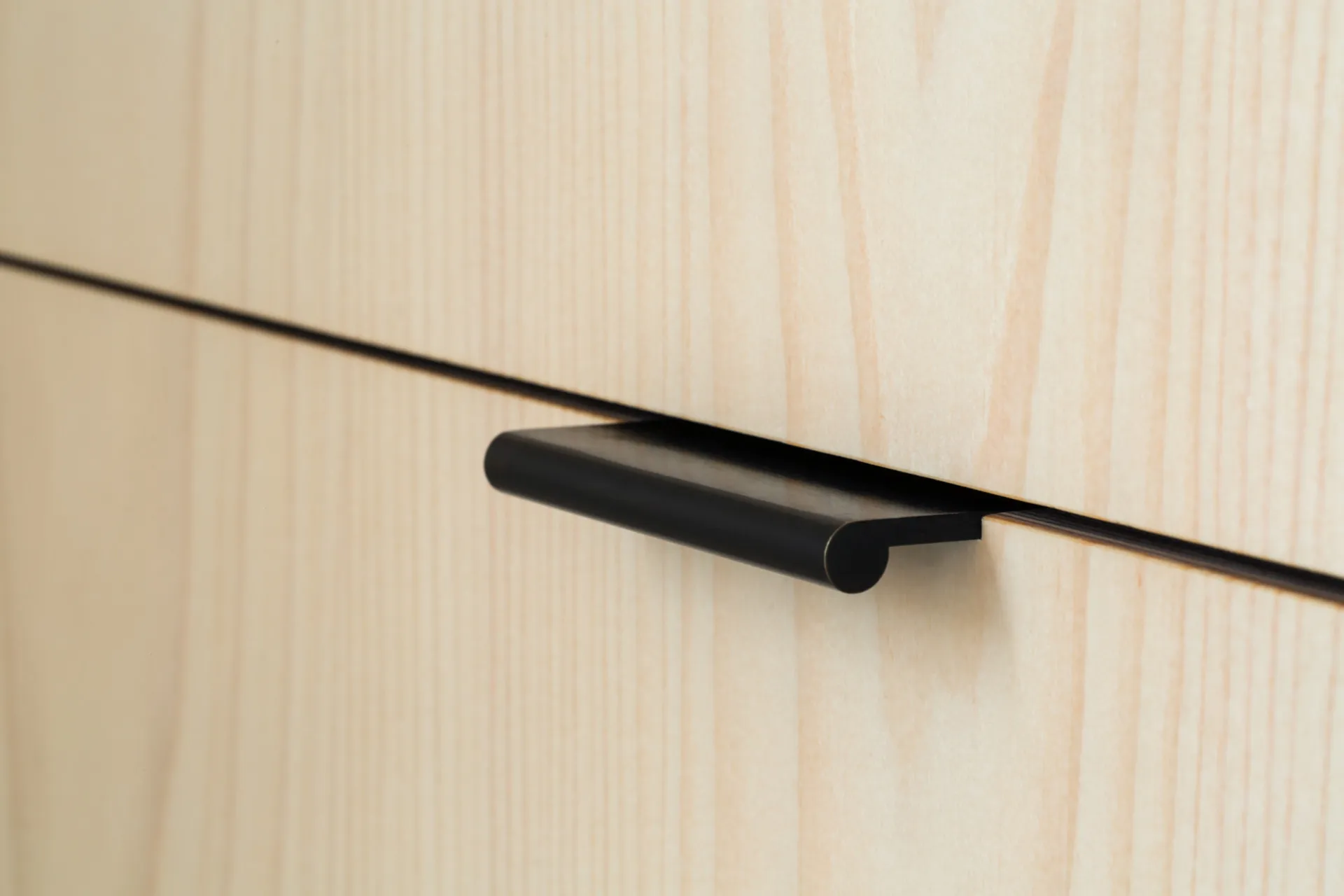 Detail of an edge pull in an ‘Overlay’ style kitchen.