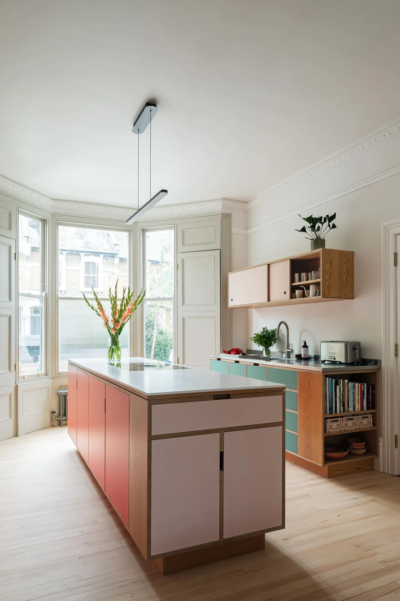 Deep cabinets for cookware, shallow bookshelves for recipes—every side has a role.