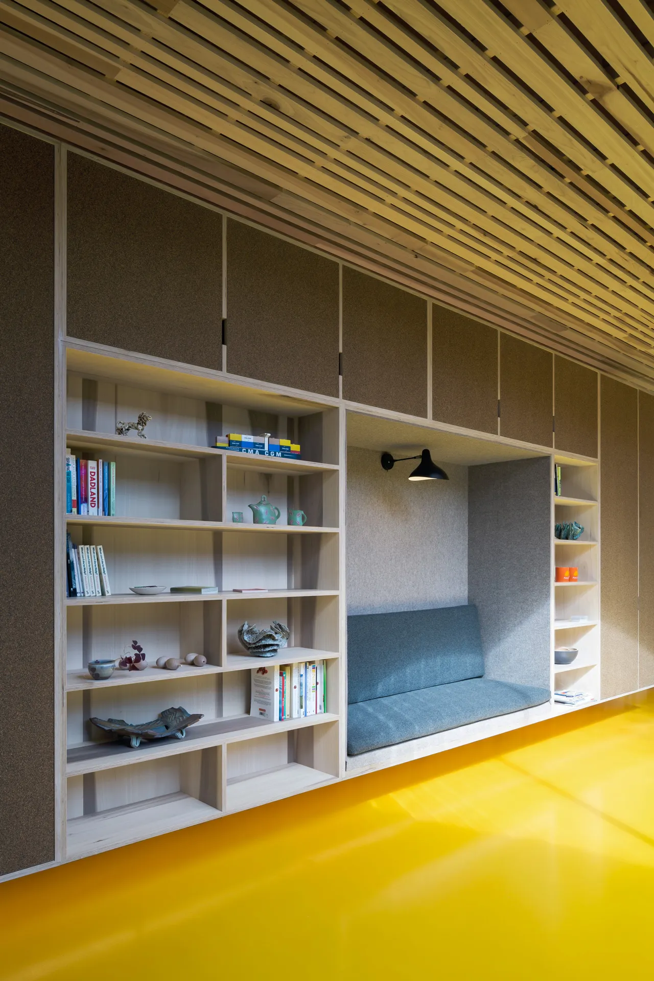 This large storage wall is completely wall mounted. Made from poplar-veneered birch plywood, it features a soft seating area.