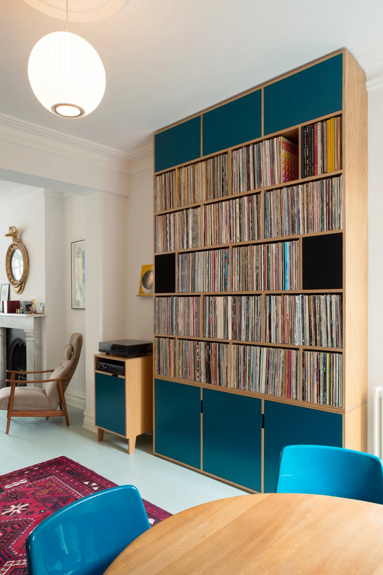 In this room for a vinyl collector, the shelves were sized to perfectly fit a record sleeve. Speakers are built-in on either side of the unit.