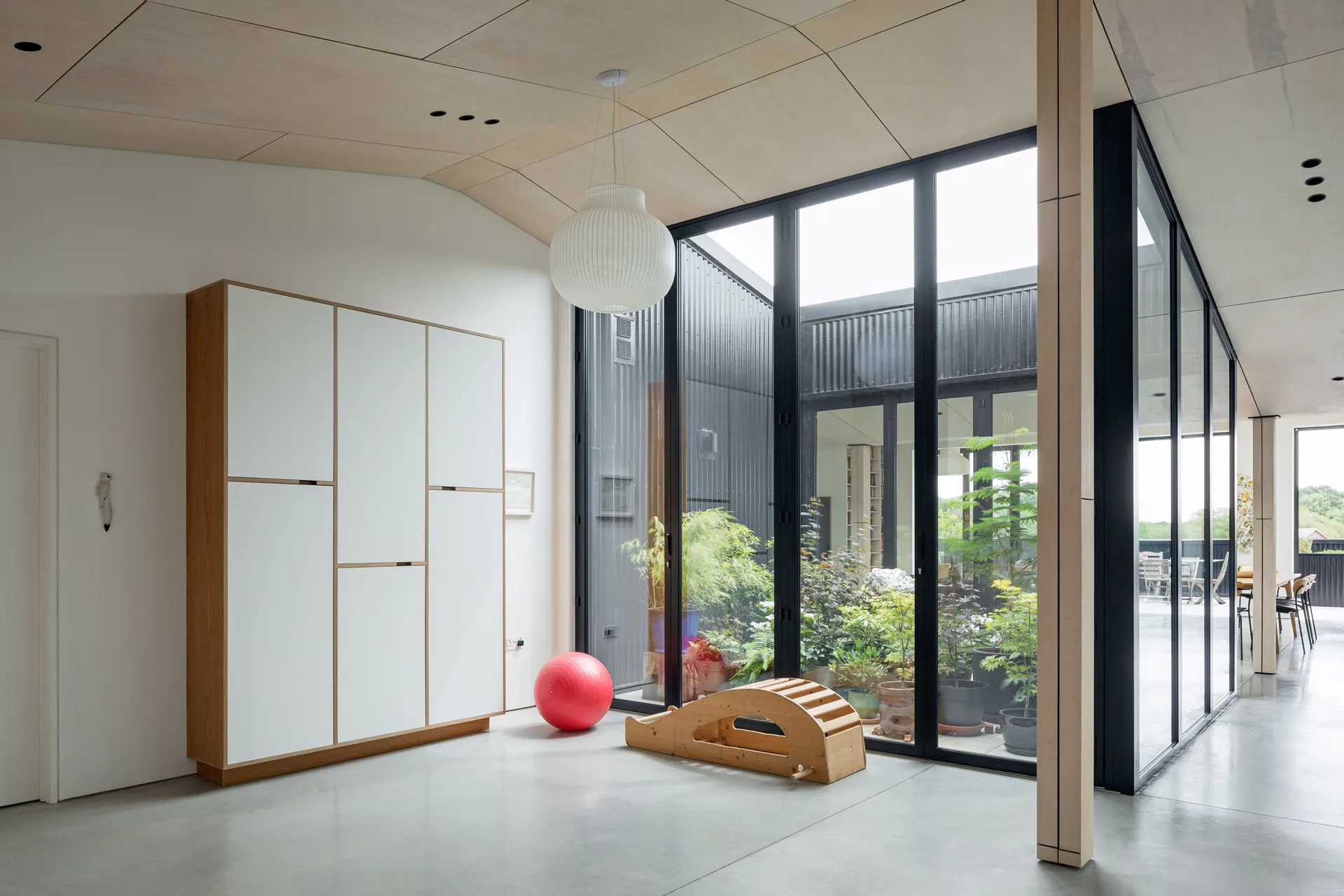 This simple ‘edge’ unit is the perfect storage for this plywood yoga studio. 