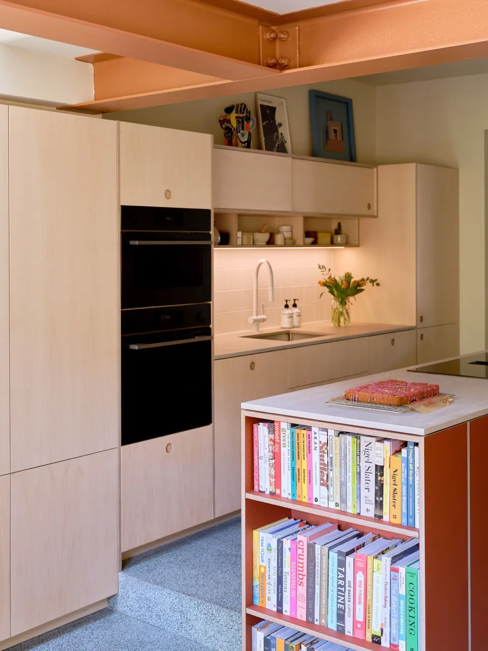 Bespoke birch plywood kitchen for baker Edd Kimber in his Walthamstow home, designed by Uncommon Projects with maple veneer cabinetry, integrated AEG ovens, Caesarstone worktop and open shelving.