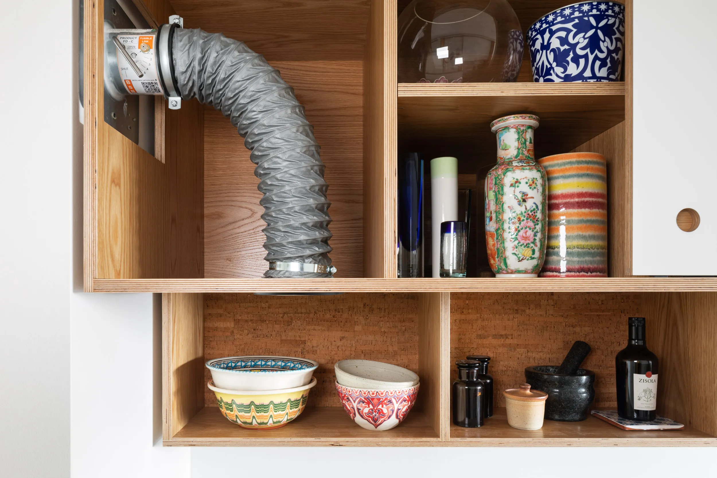 Bespoke plywood overhead cabinet with integrated extractoin