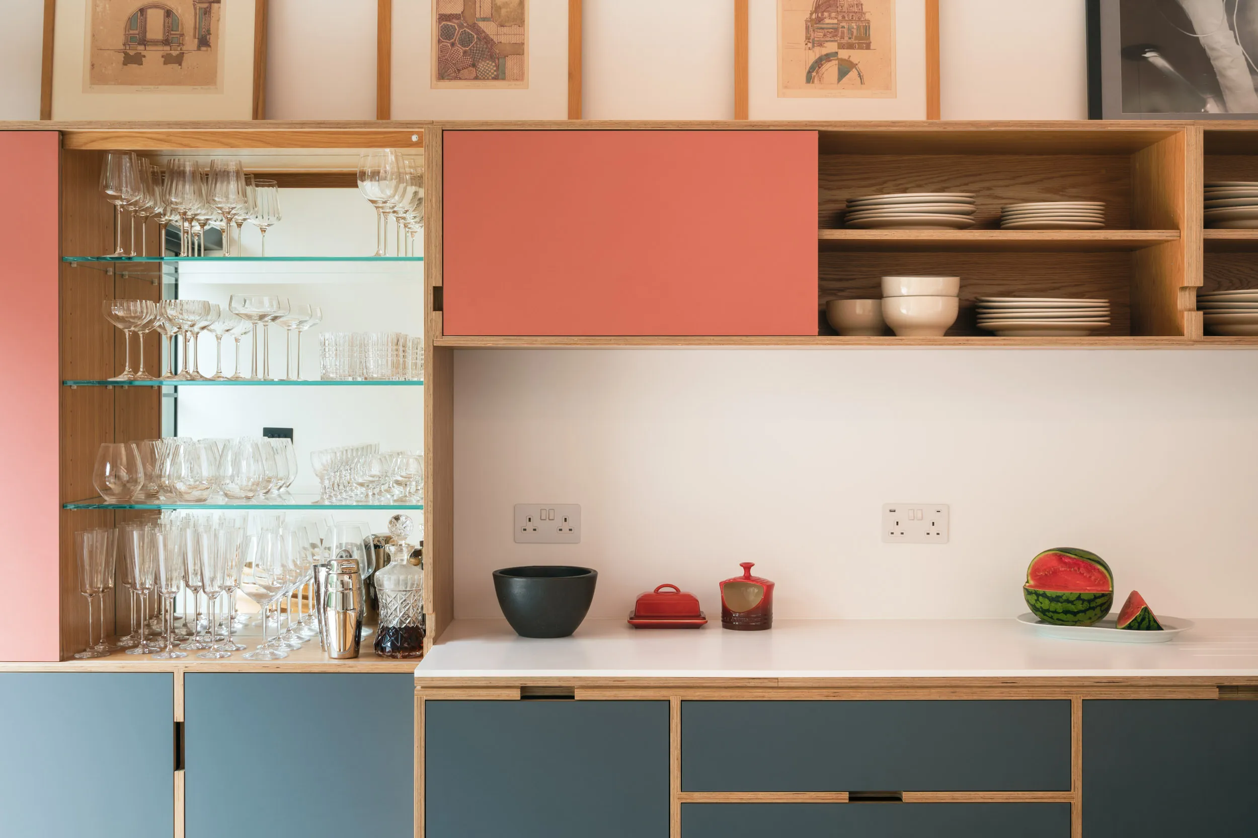 Pink ceiling and plywood kitchen close up with breakfast bar