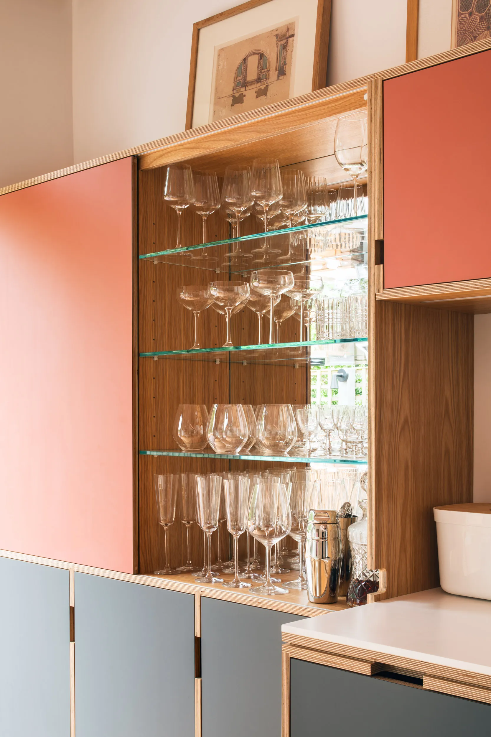 Pink and Grey drinks cabinet in the sun. MIrror inside and glass shelves.