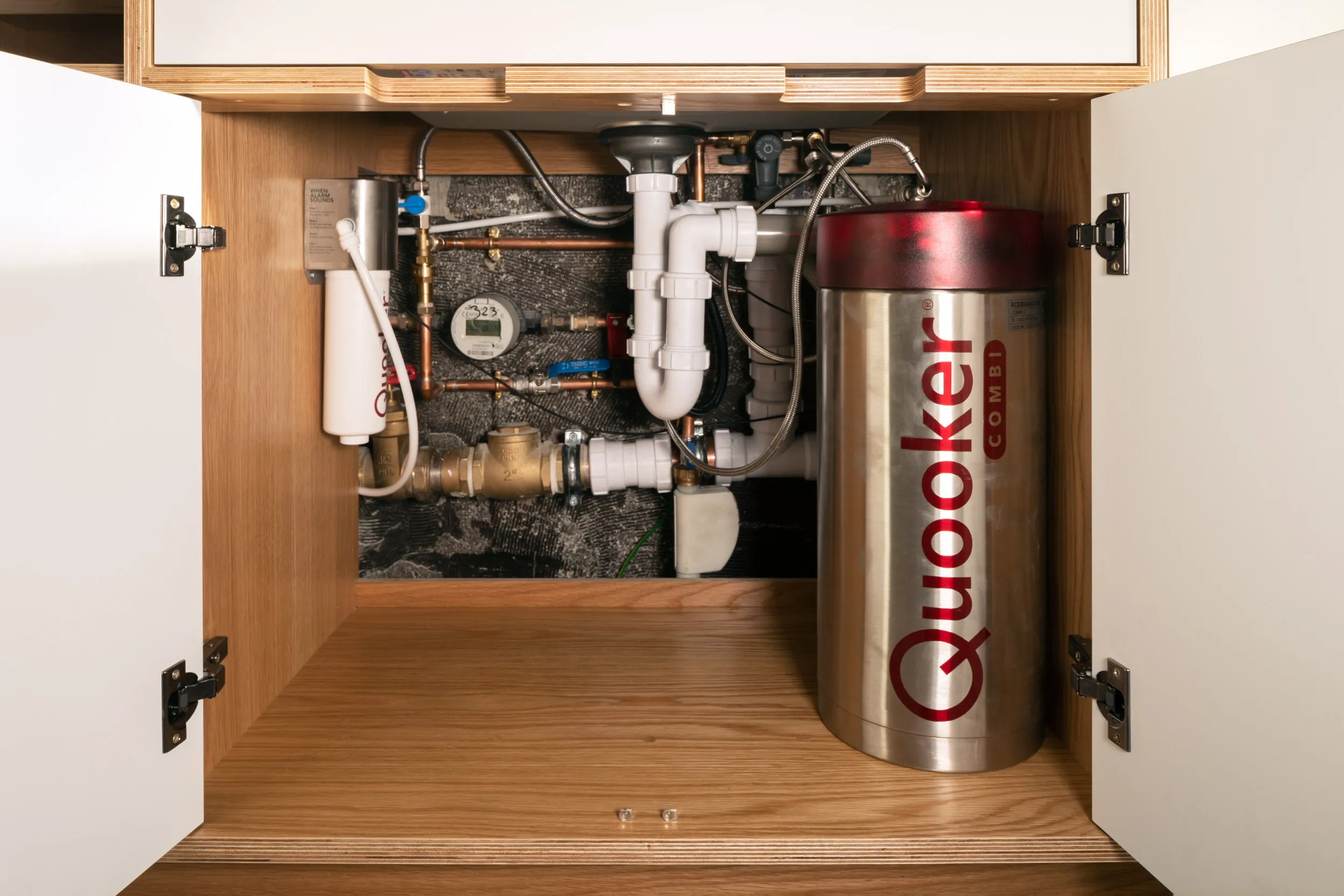 Plywood kitchen cabinetry with Quooker tank