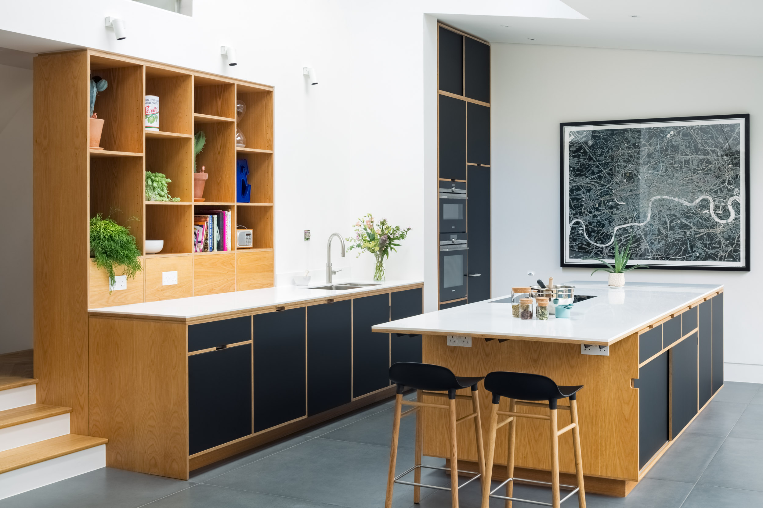 Birch plywood kitchen with oak veneer. Large concrete tiled floor and black laminate