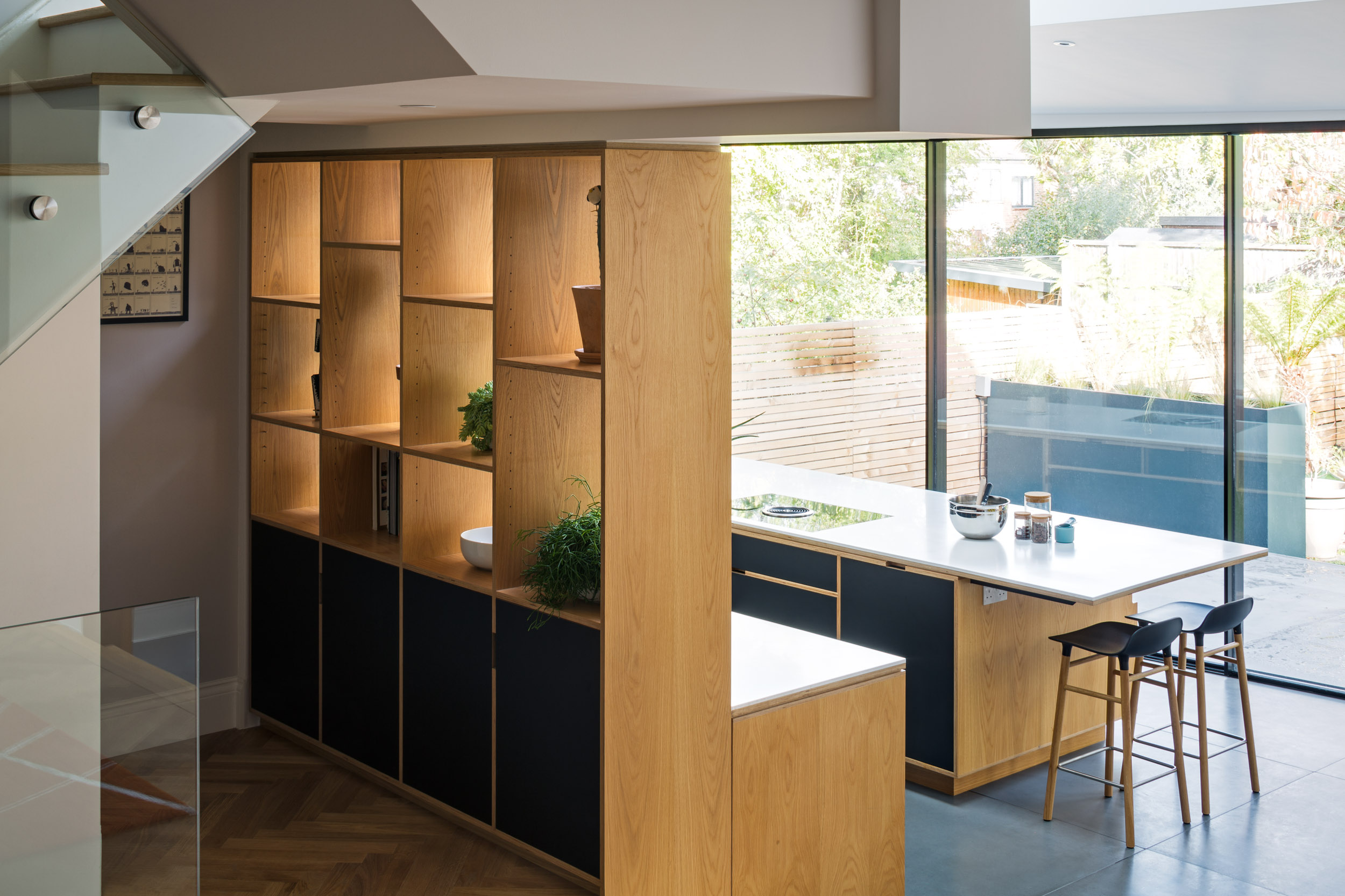 Double sided open book case, overlooking kitchen and bathroom.