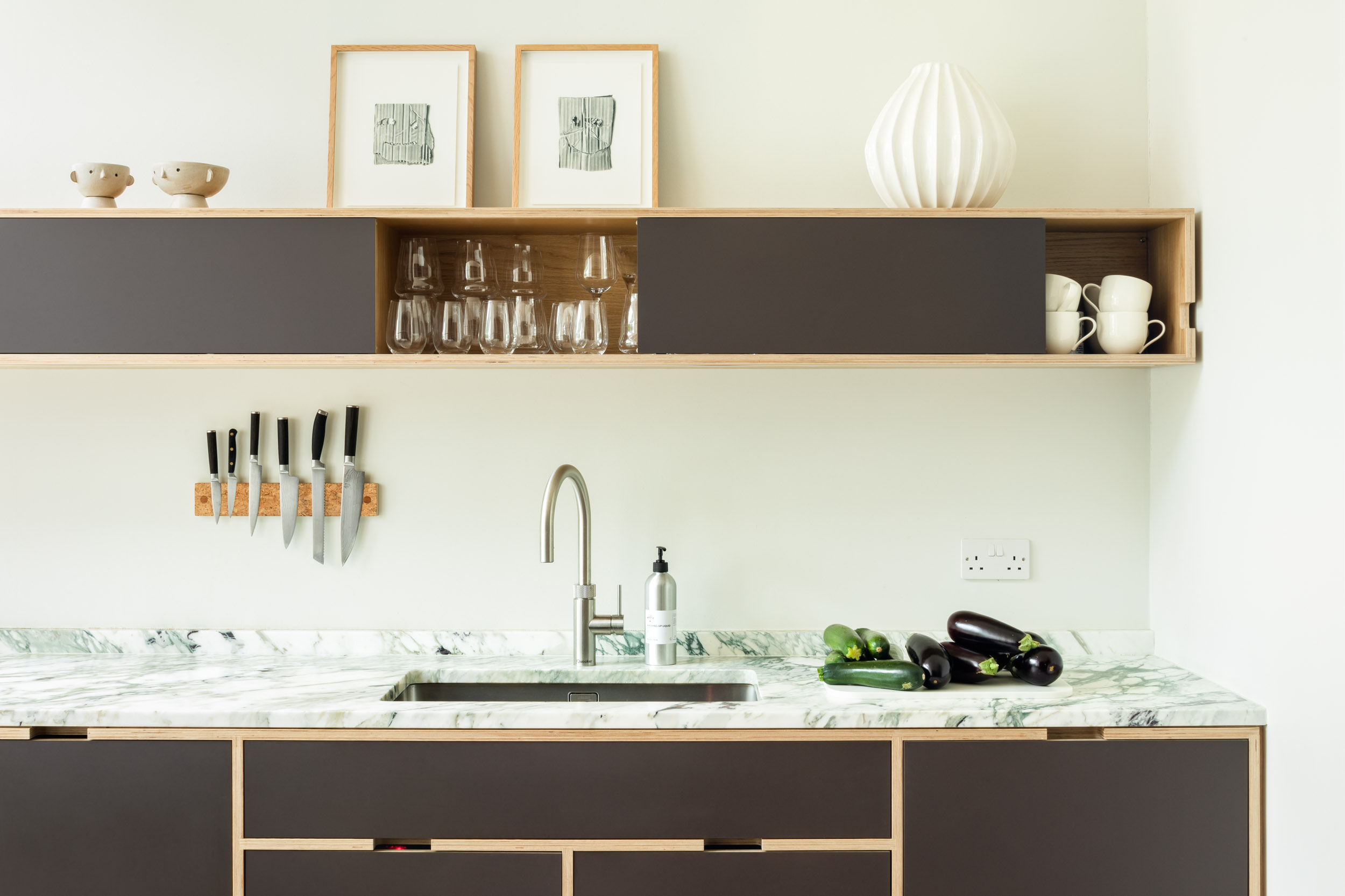 Marble worktop, handless ply cabinetry and brown doors