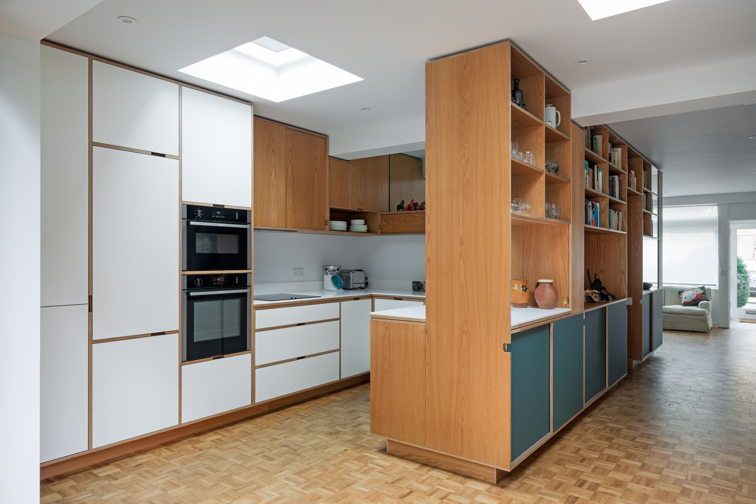 White and oak plywood kitchen with mirror backing