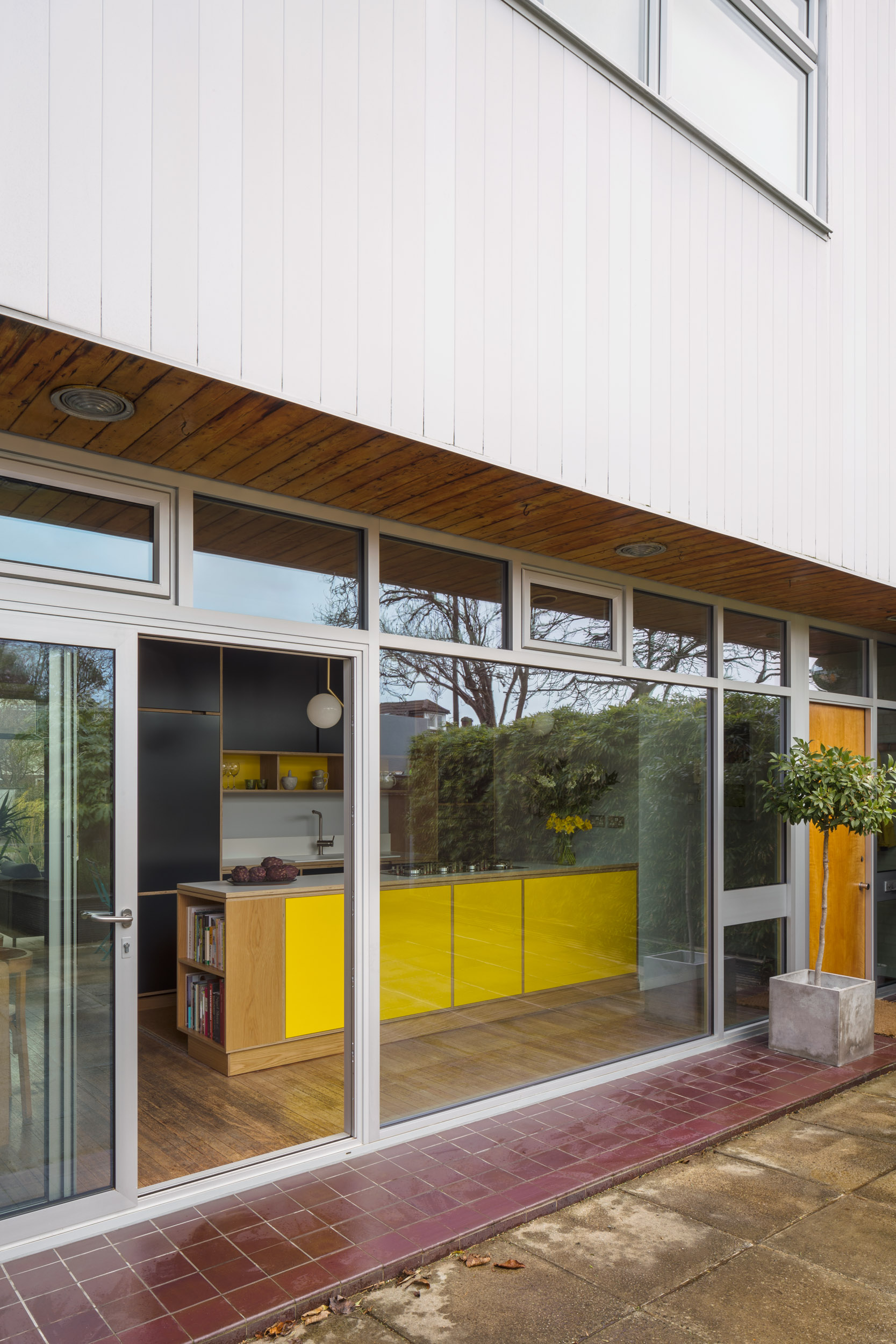 External view of plywood kitchen. Looking in from garden.