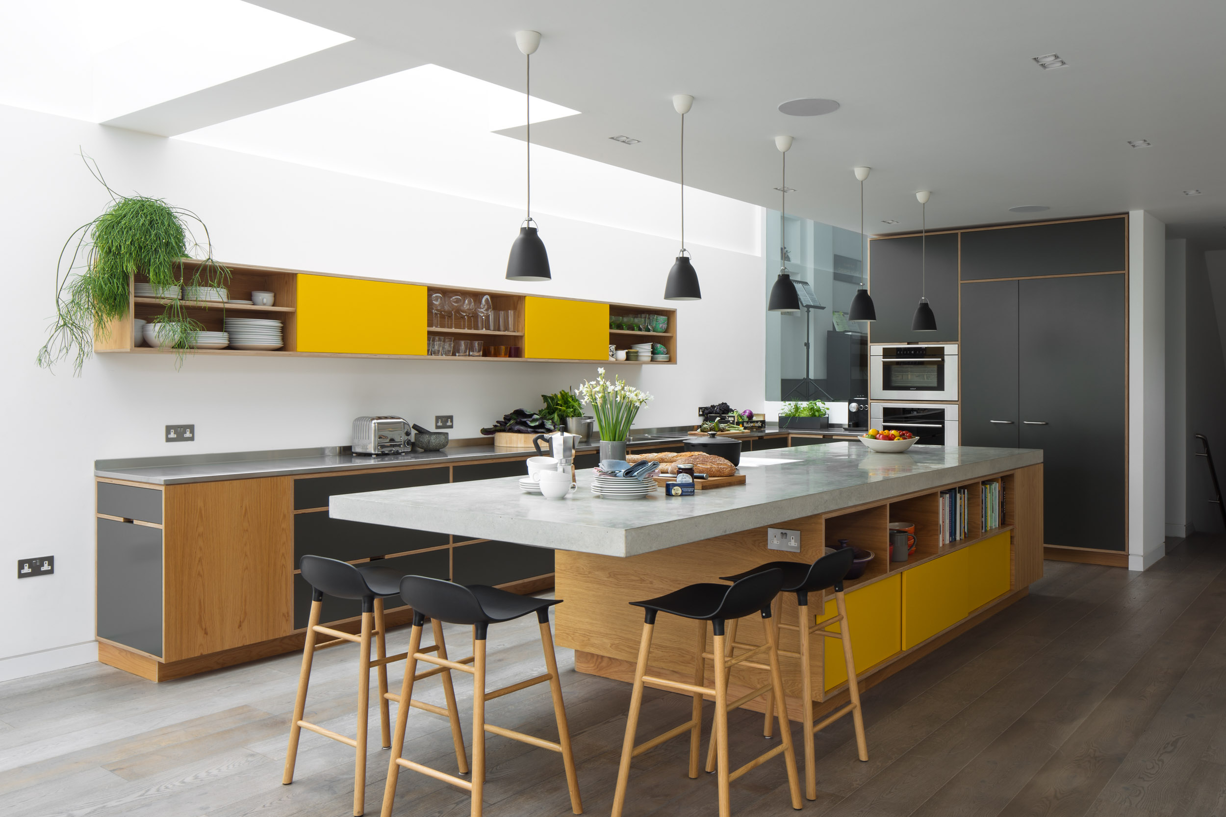 Concrete cantilever worktop on bespoke plywood island