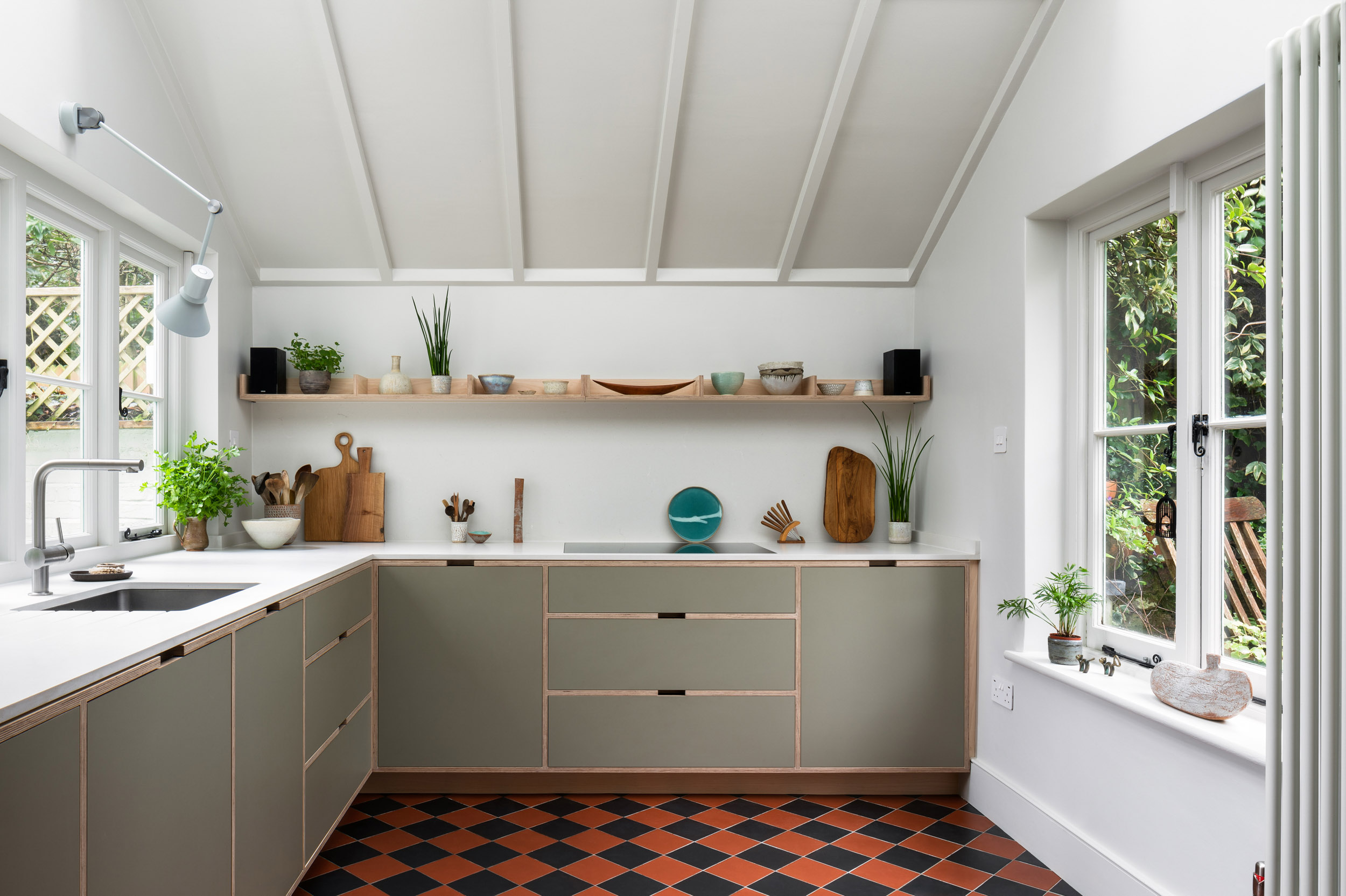 Modern bespoke plywood kitchen in a Victorian farmhouse with ash veneer cabinetry, large sash windows and terracotta tiled floor by Uncommon Projects.