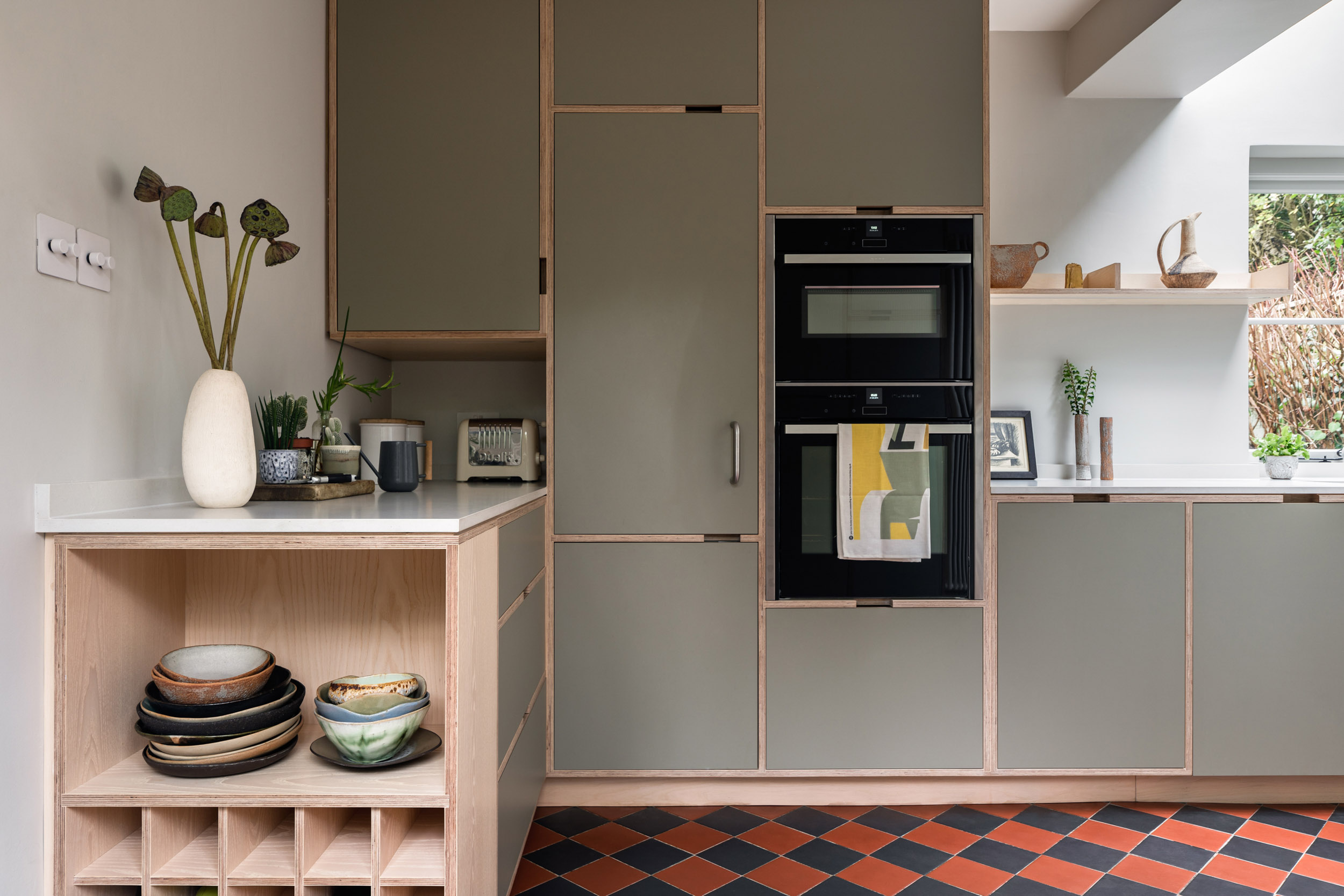 Open shelving and bespoke plywood storage detail with ash veneer finish in a modern Uncommon Projects kitchen.