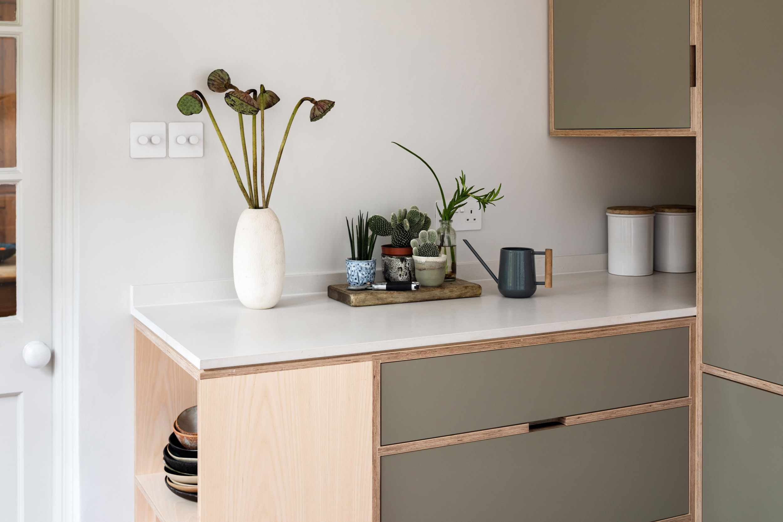 Close-up of bespoke plywood kitchen joinery with integrated drawers, ash veneer cabinetry and handcrafted detailing by Uncommon Projects.
