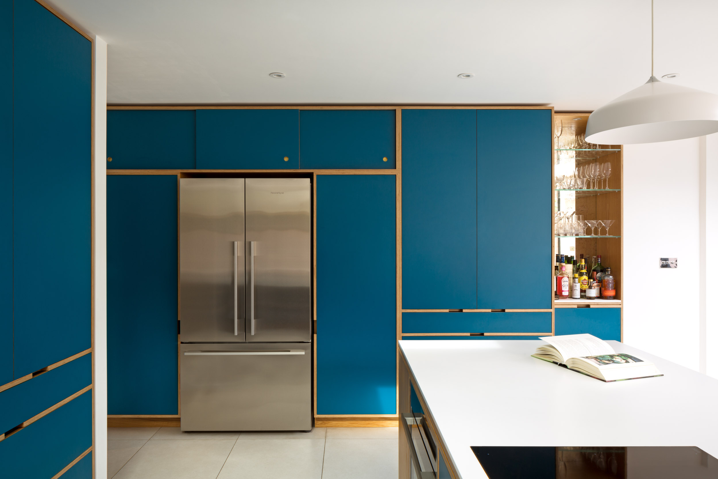 Bespoke plywood kitchen in teal with Fisher Paykel fridge freezer