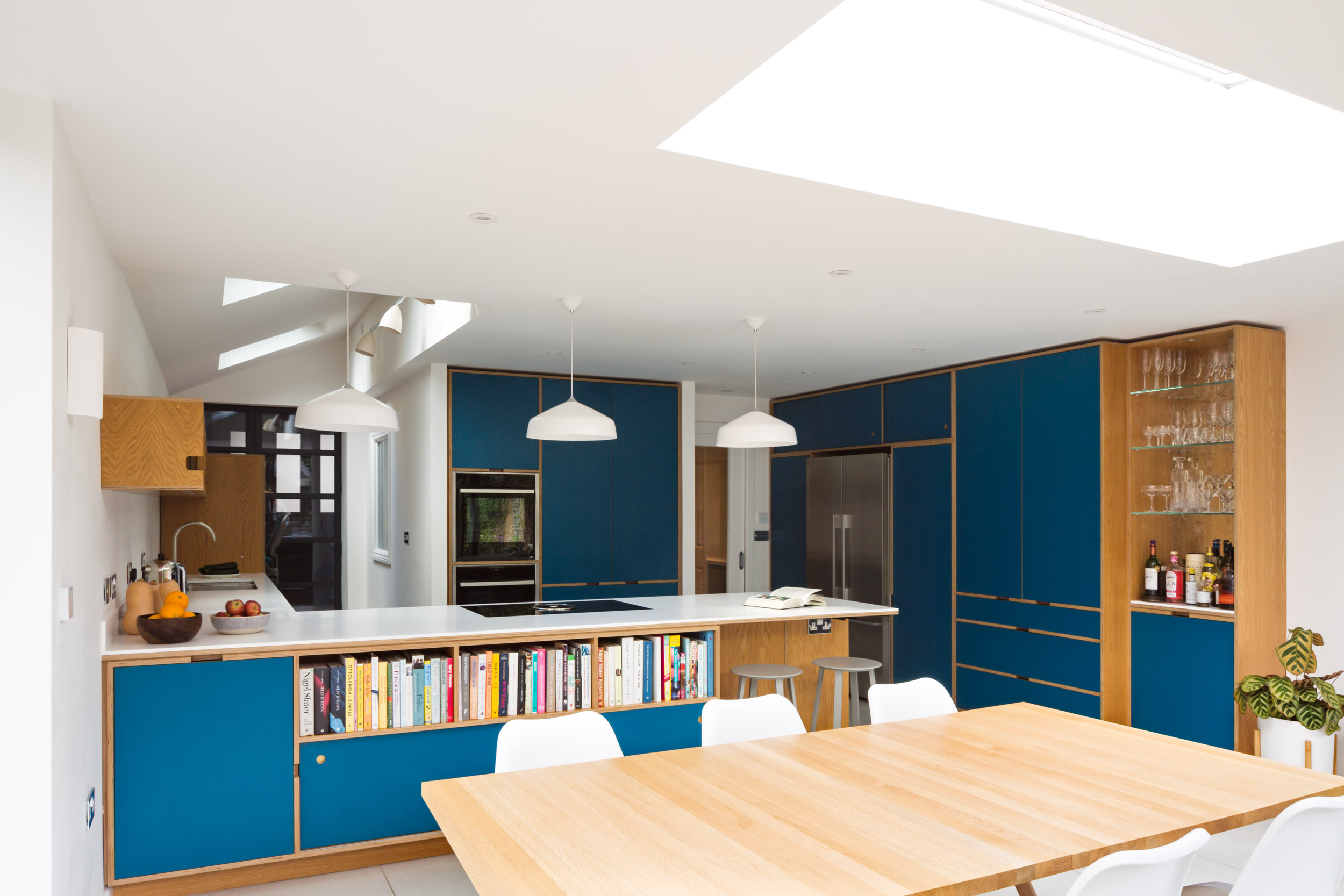 Bespoke plywood kitchen in teal and oak.