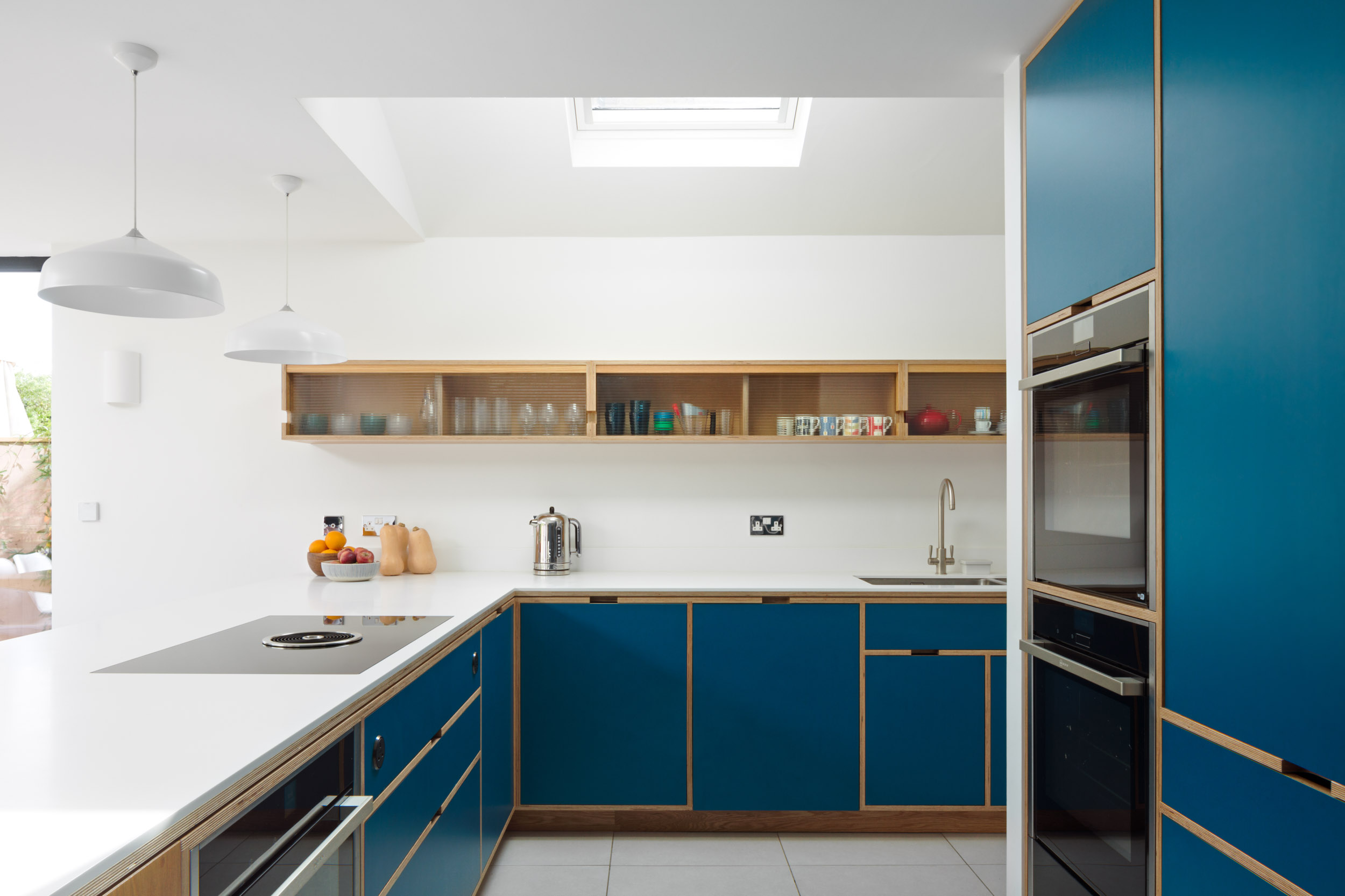 Bespoke plywood kitchen with fluted glass wall cabinet