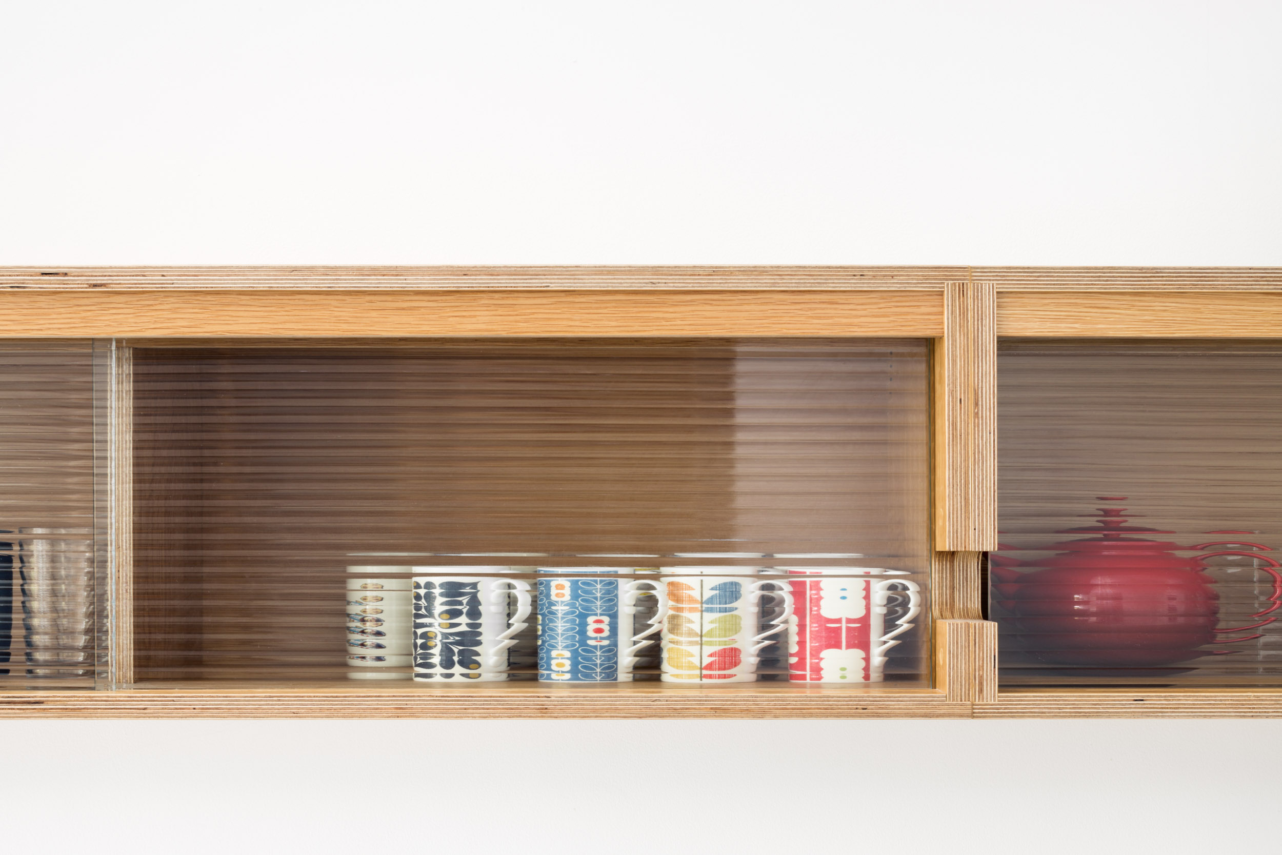 Reeded glass doors on plywood wall cabinet