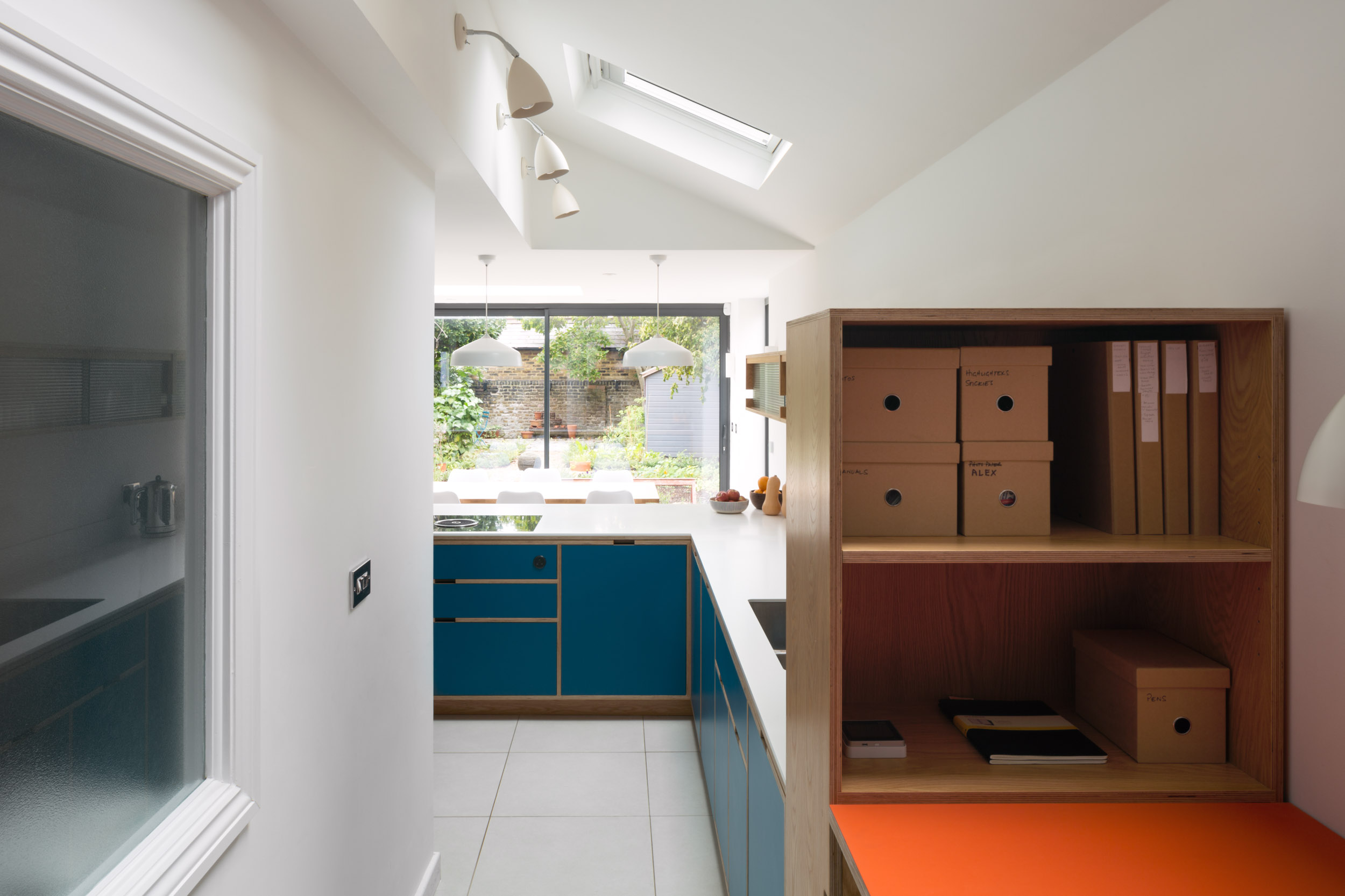 Bespoke plywood work from home desk with kitchen behind