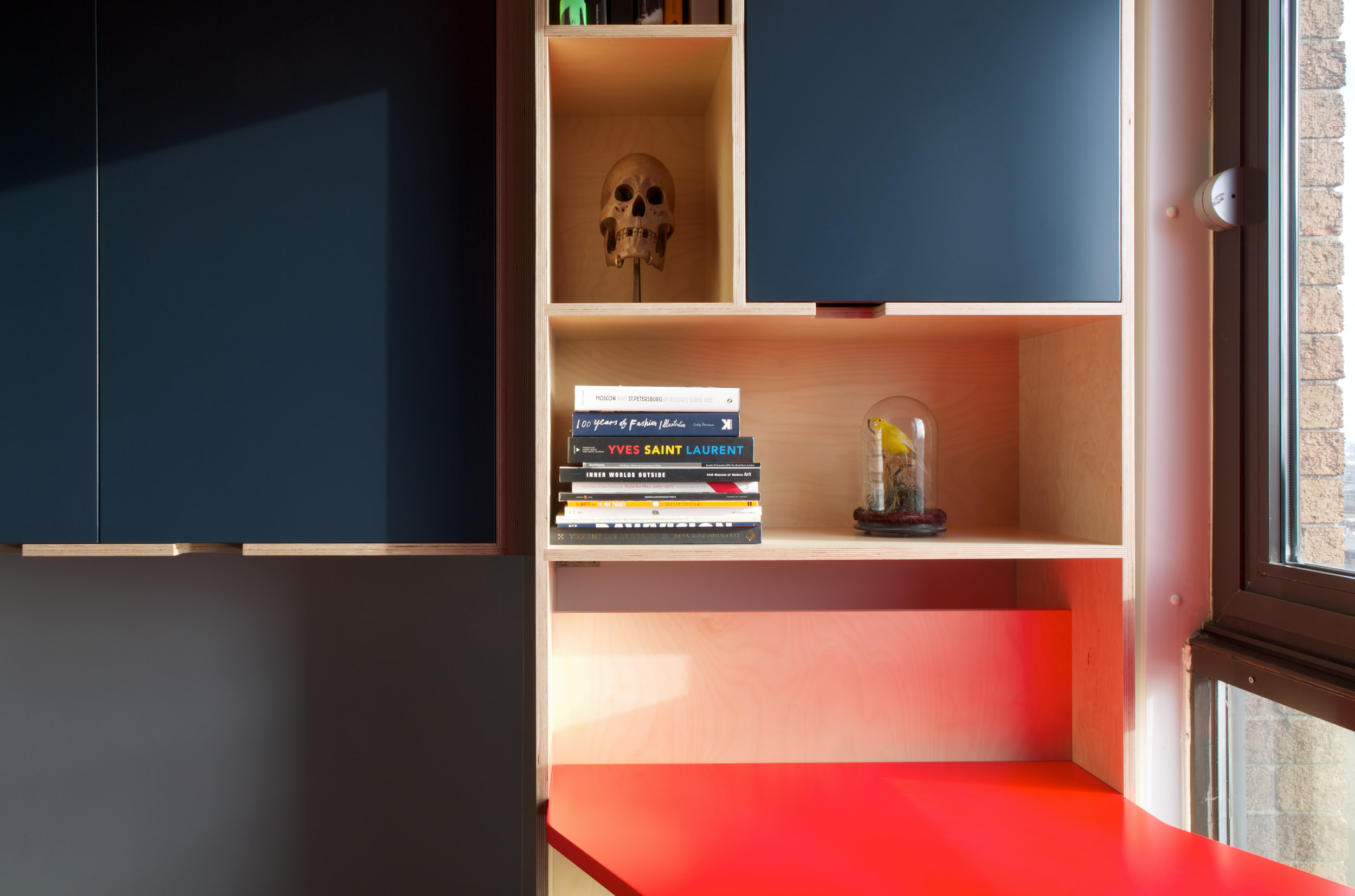 Plywood Bookshelf Next to neon Red Ply Desk