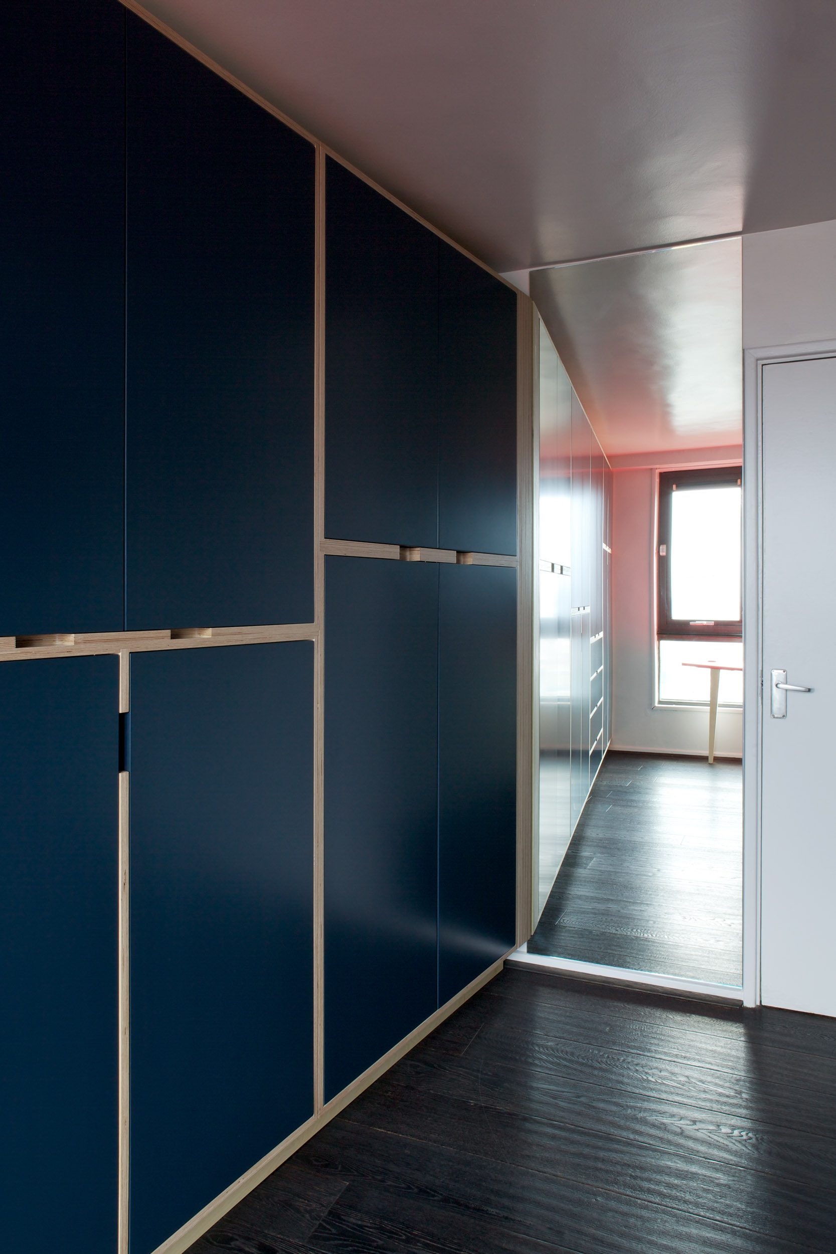 Plywood Wardrobe Next to Mirror - dark moody blue