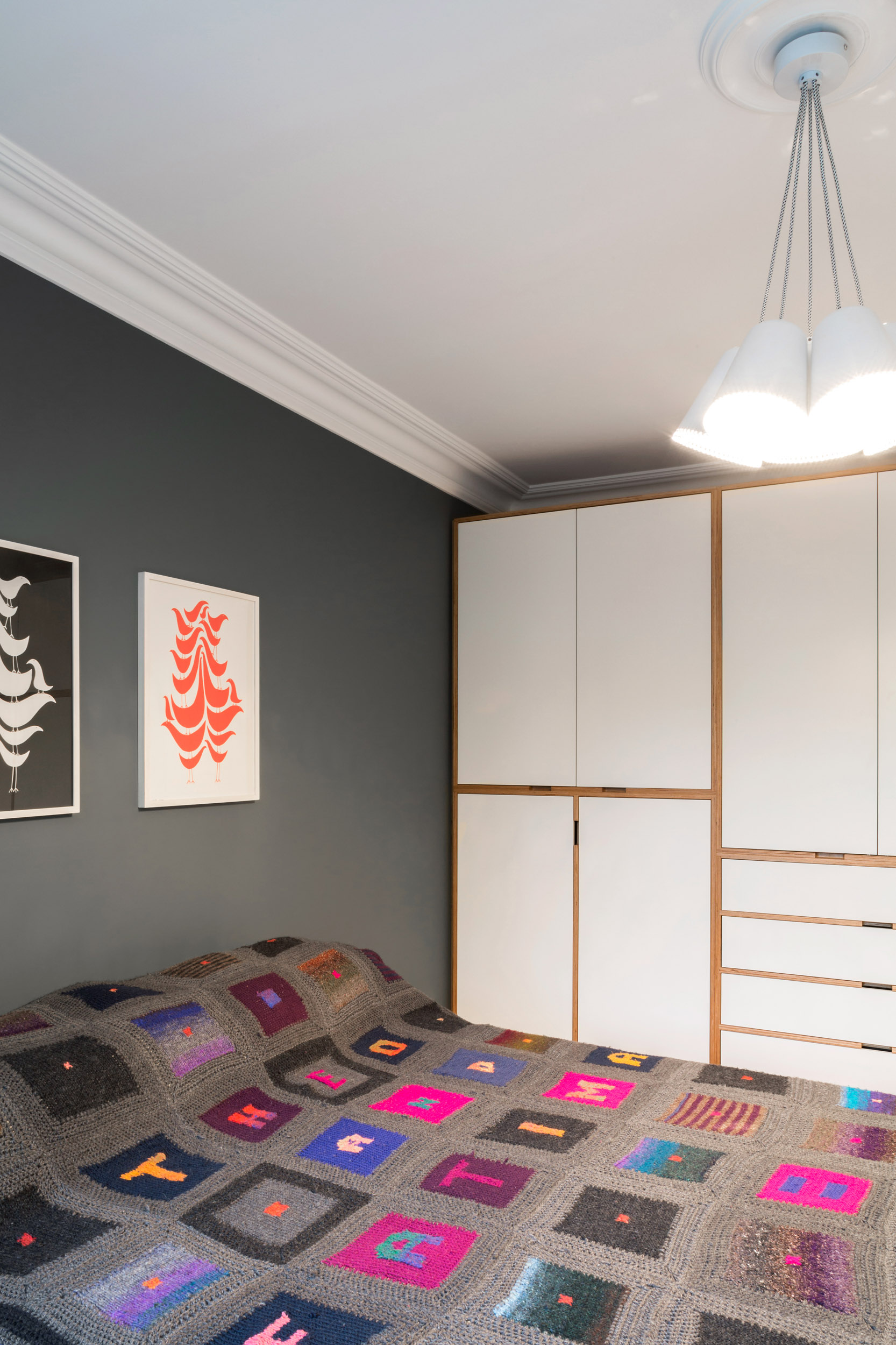 A full height ply wardrobe with white doors in a bedroom.