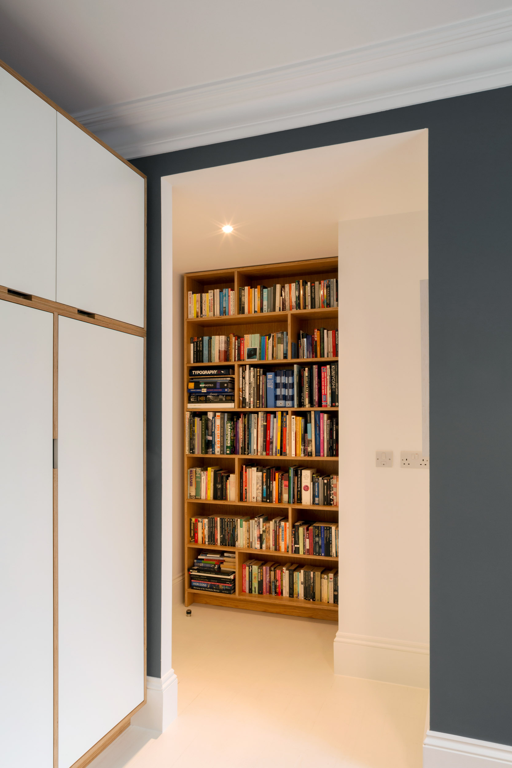 A full height ply wardrobe with a view to a full-height ply book shelf.