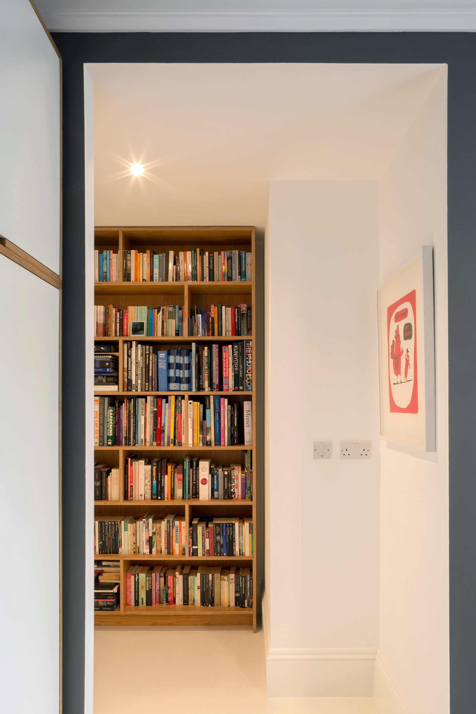 A full height ply wardrobe with a view to a full-height ply bookcase.