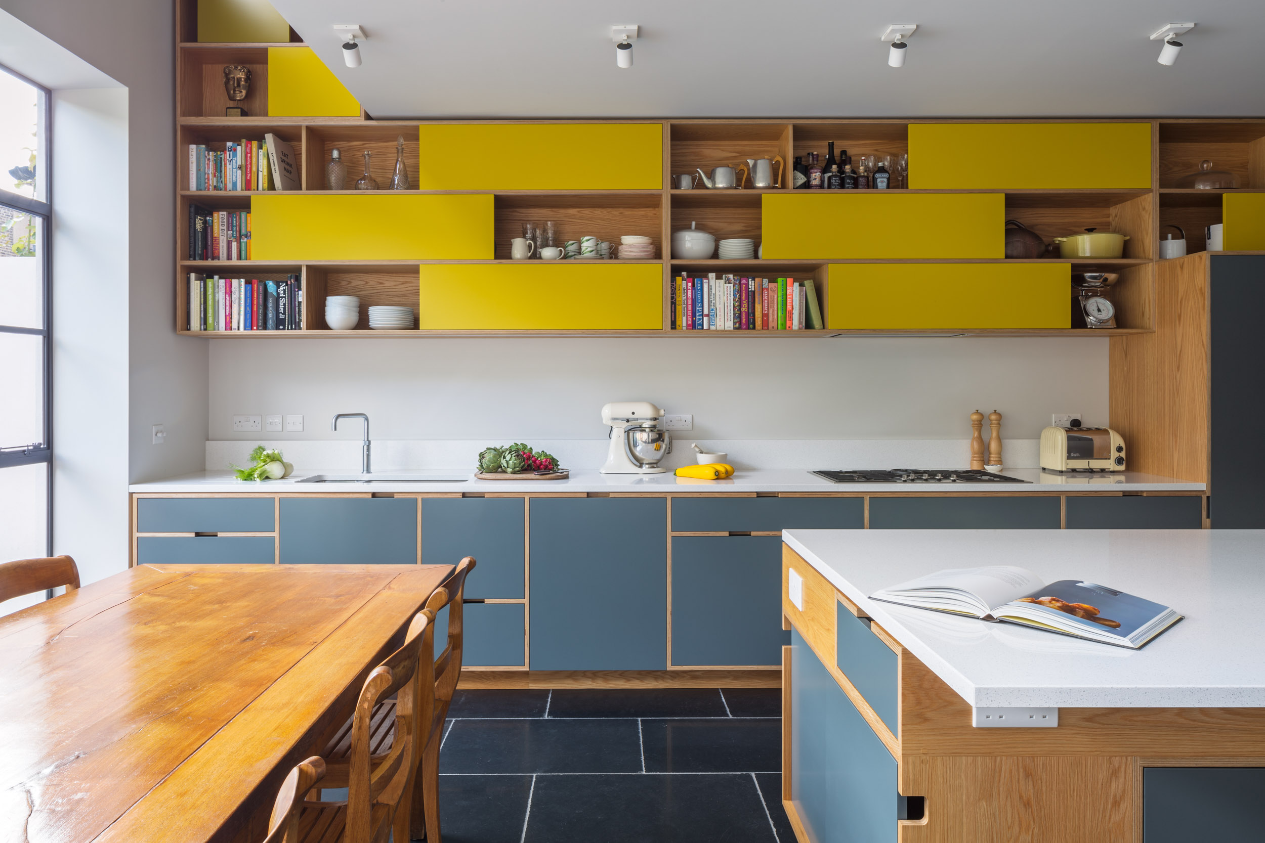 Light grey plywood kitchen with yellow sliding door wall cabinets