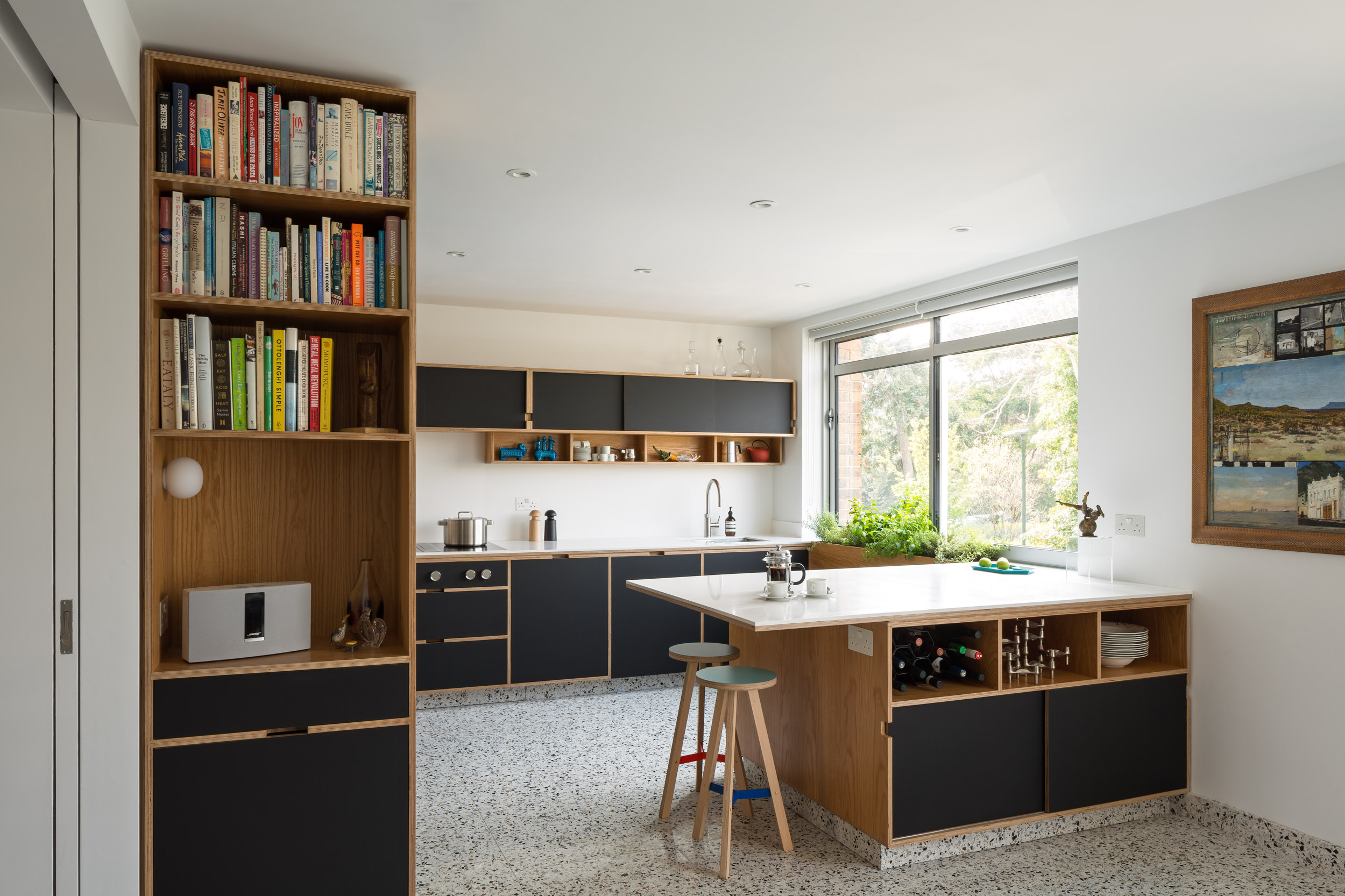 Black doors on a plywood bespoke with kitchen island