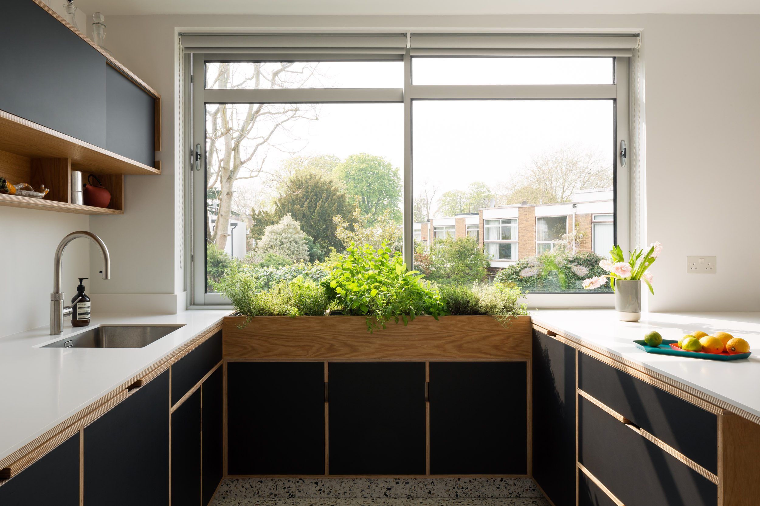 Black doors on a plywood bespoke with kitchen island