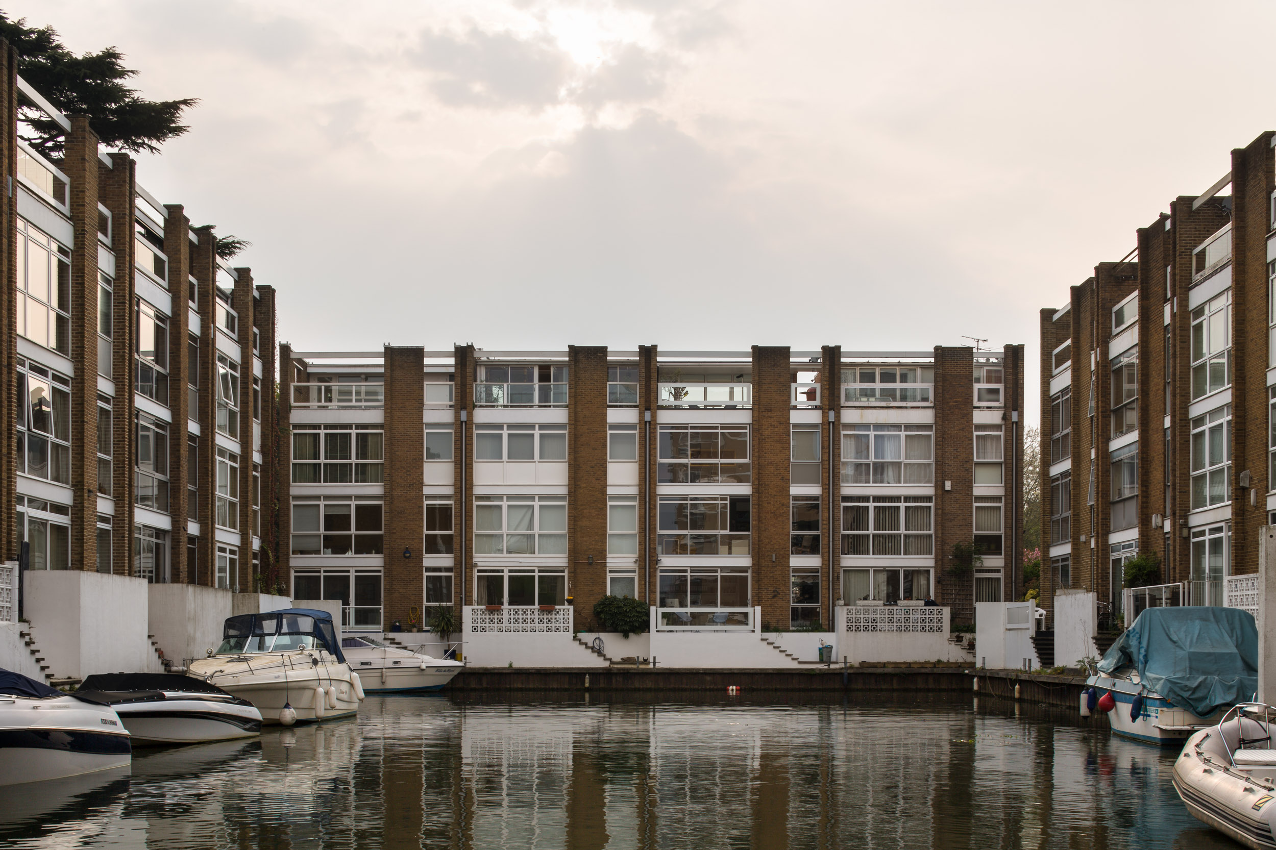 Mid century property on river with boats.