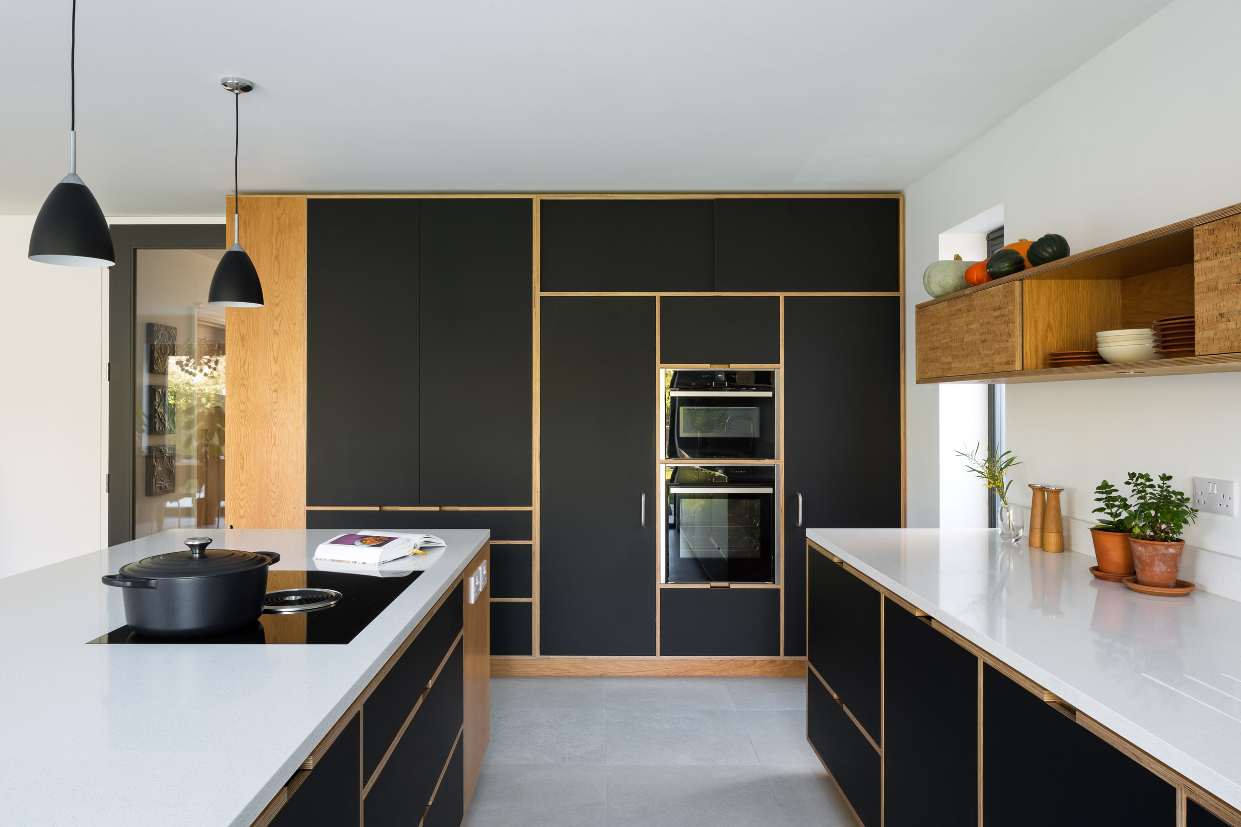 Large bank of black full height kitchen cabinetry