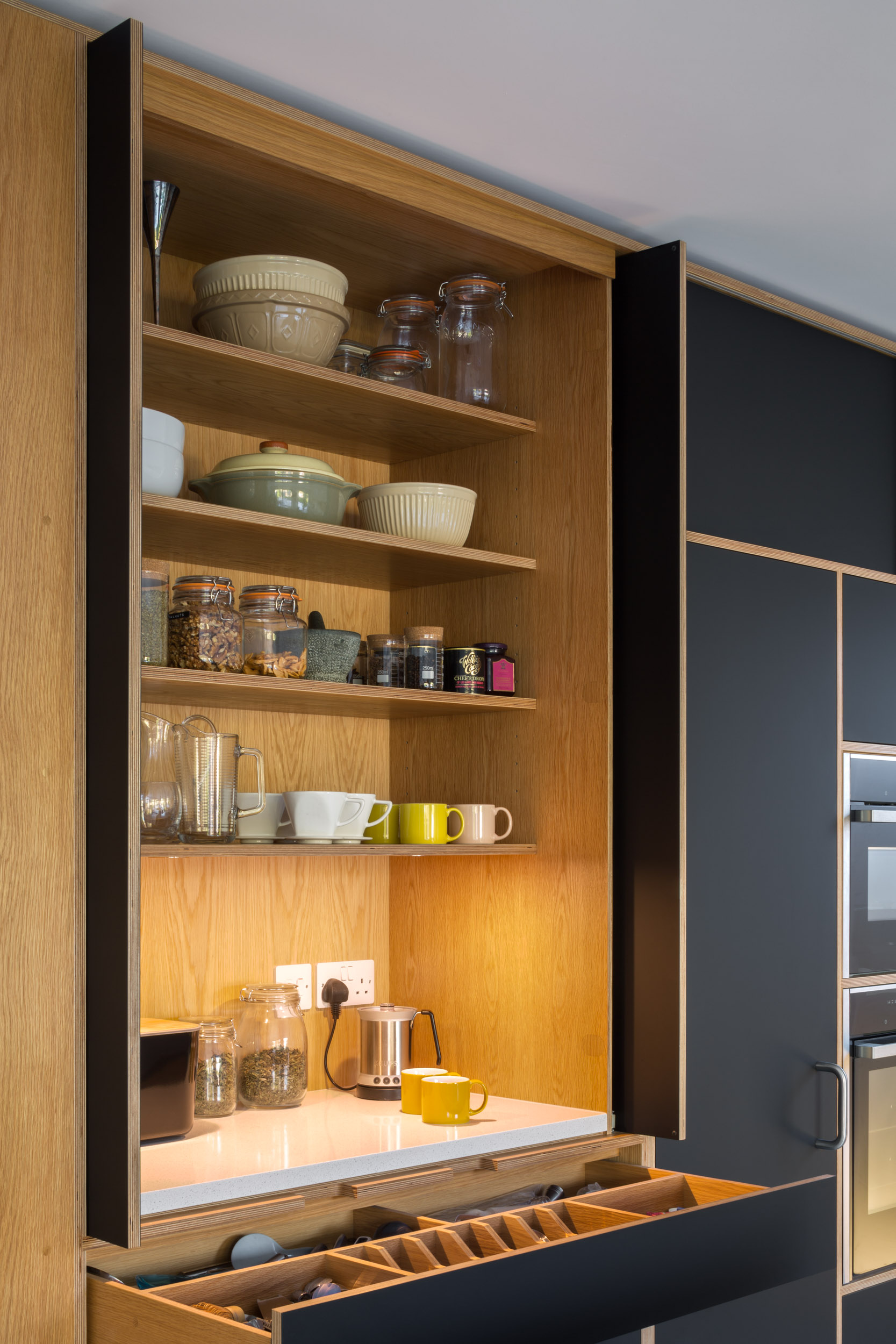 Bespoke plywood pantry cupboard with pocket doors