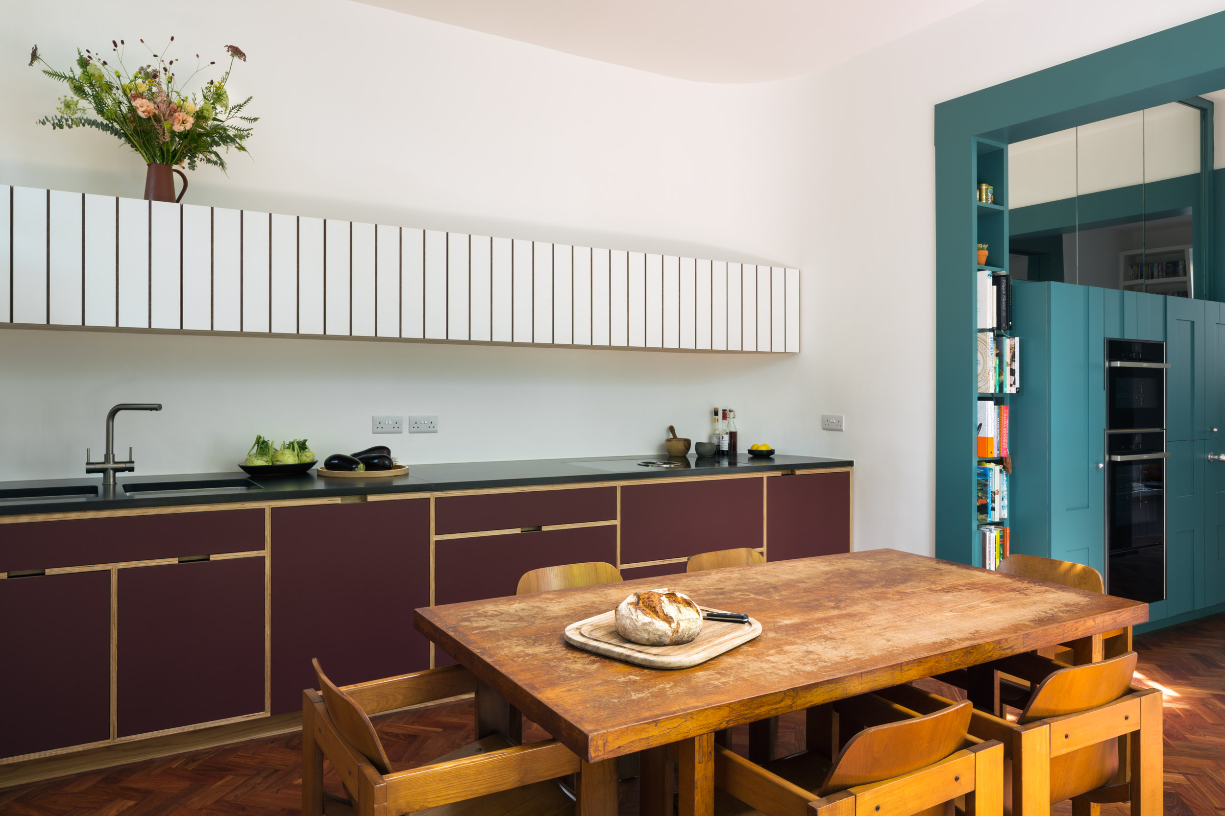 Maroon and white plywood bespoke kitchen overview
