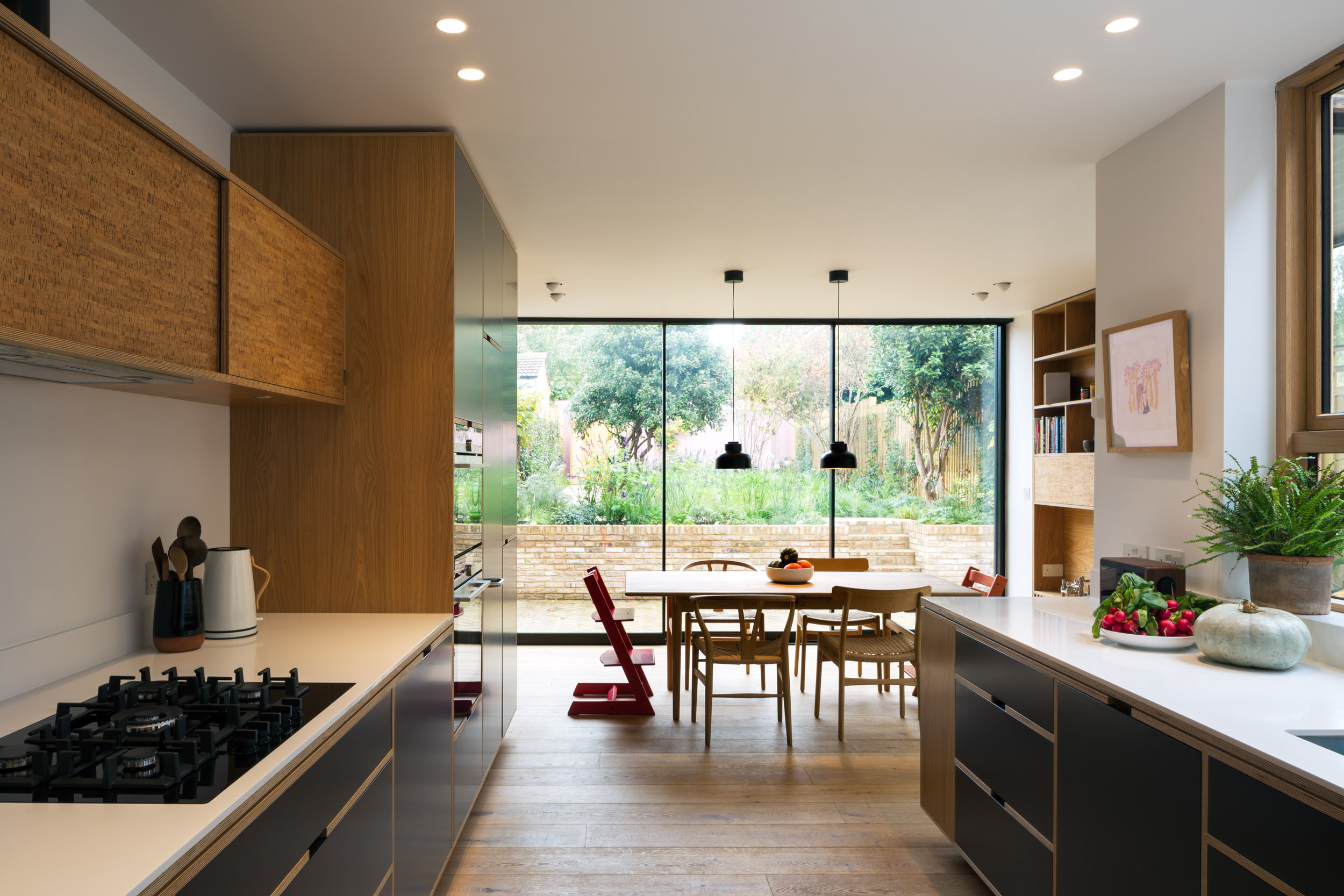 Birch ply bespoke kitchen and dining room with oak veneer. Large dining table.