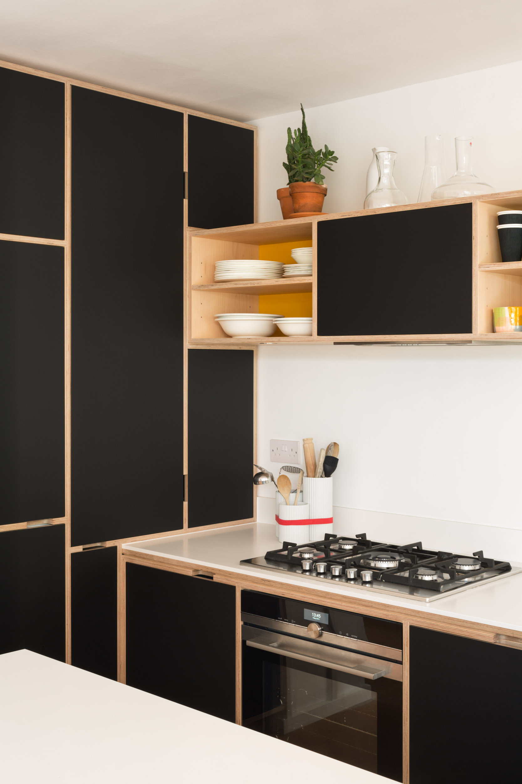 Black doors on plywood inframe cabinetry