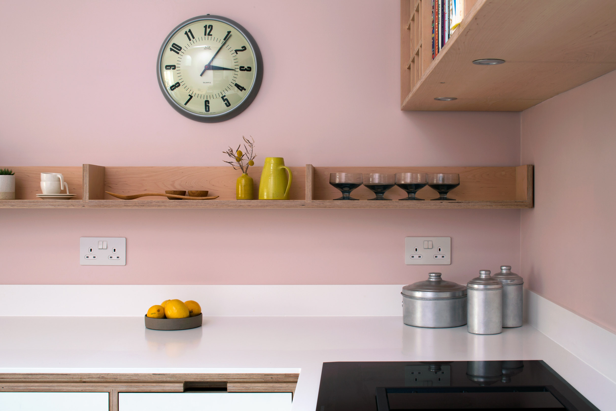 White corian worktop with maple plywood open shelving